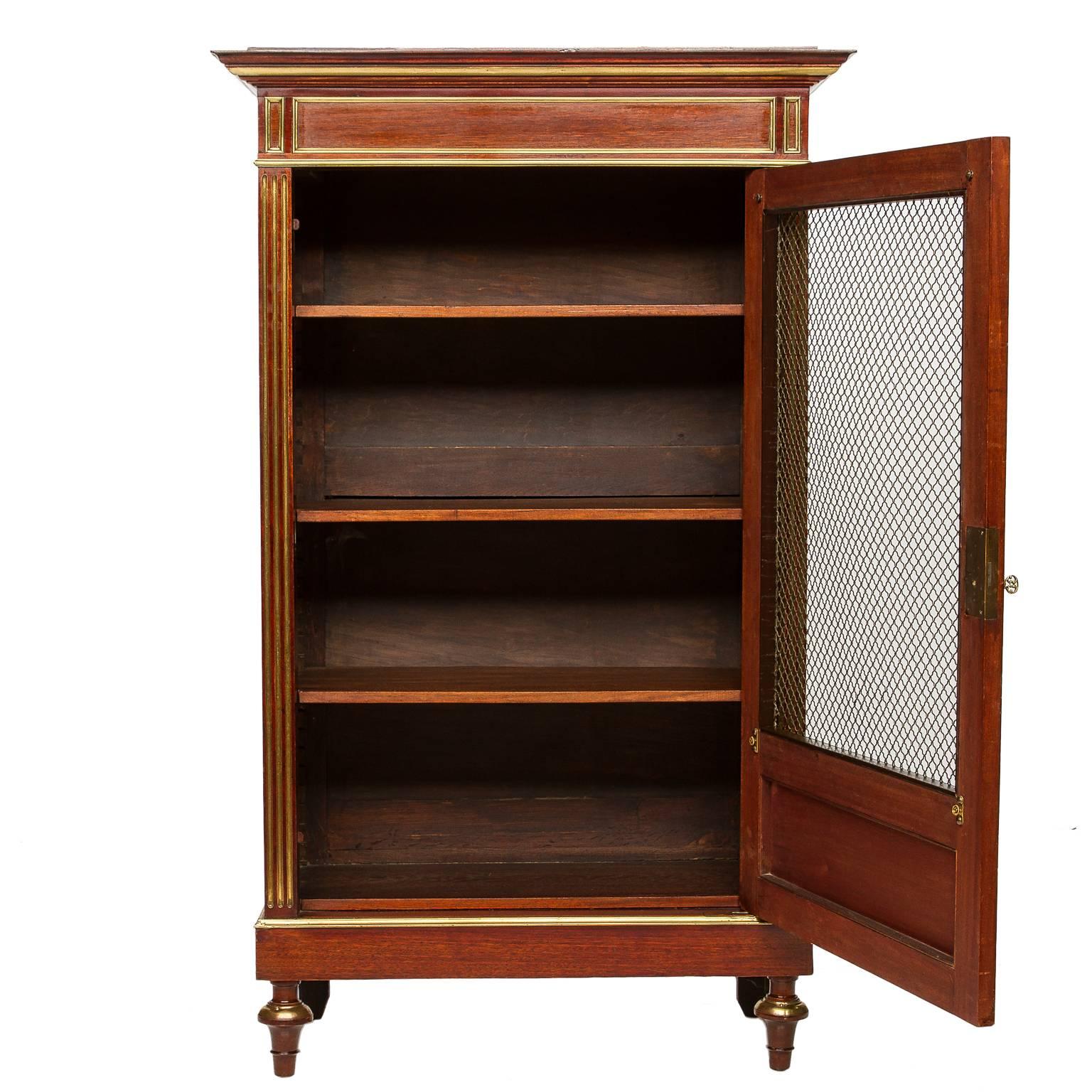 A fine example built in beautiful mahogany. Featuring recessed panels accented with brass trim, brass screen, inverted cup style front foot with brass covering. Fluted details on front casing are brass inlays which provide a wonderfully