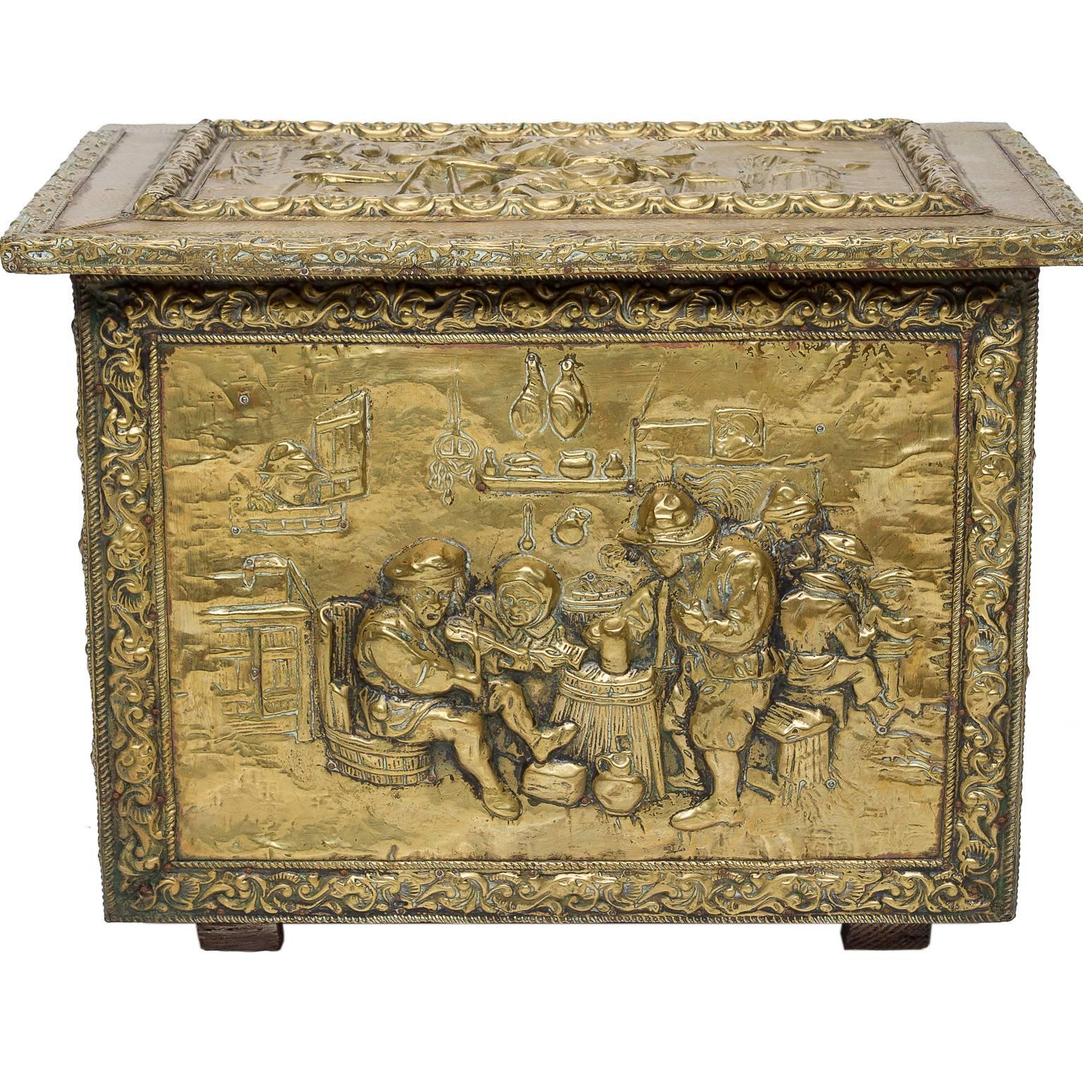 An English brass fireside lift top box from the late 19th century. This sides and front are hammered and embossed with individual scenes. Very nice quality interior and people scenes. The brass has been polished throughout the years and holds a