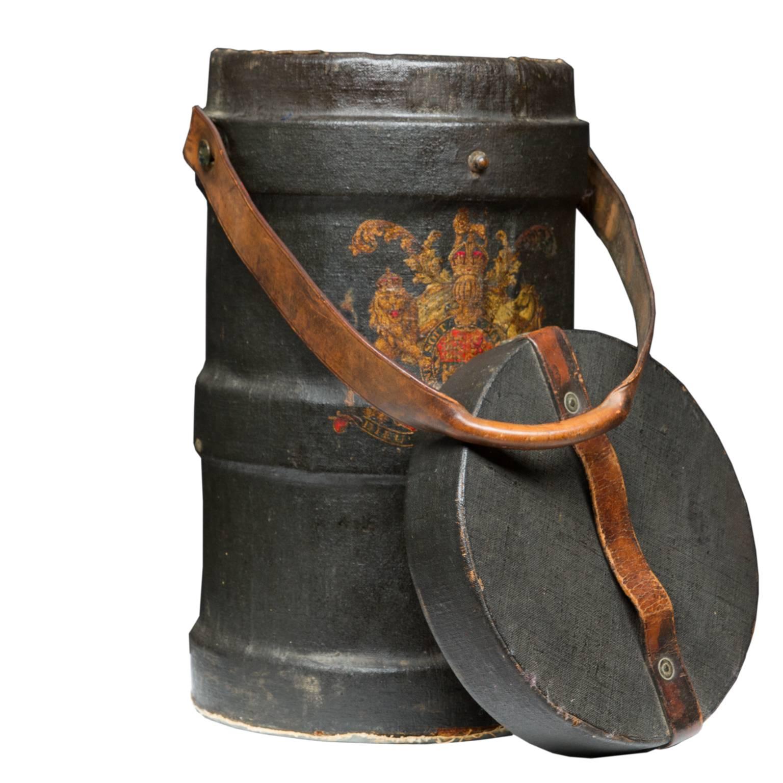 A handsome 19th century English cordite case with leather carries strap, lid, and a coat of arms on the front. Nice heavy strap for carrying and top leather strap. No locking strap has been broken off. Made of painted canvas. Very nice quality.