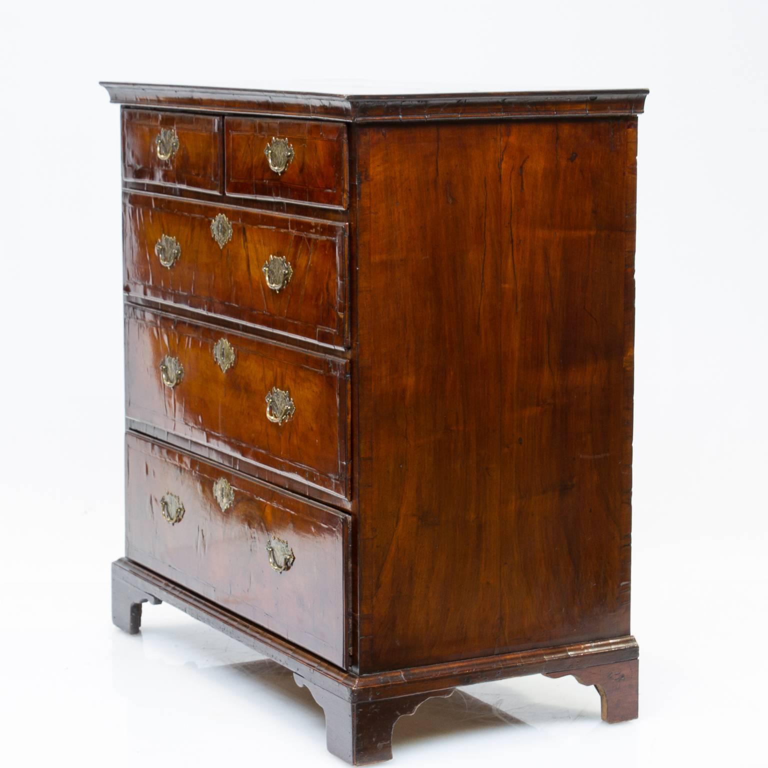 18th century Queen Anne walnut two over three chest of drawers. This chest of drawers has an amazing front, first the French polish is amazing and highlights the thick cut of quality veneers. The figured walnut rich in color and depth. You will see