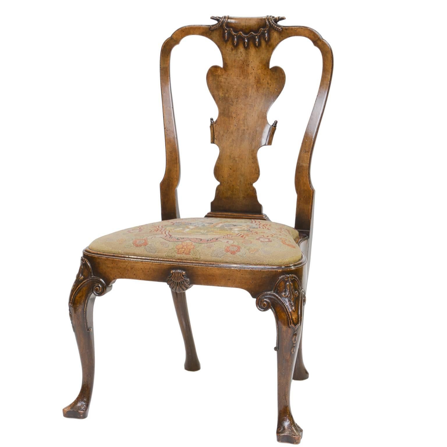A very nice set of four Georgian style walnut side chairs. Fine scroll on the crest with swags and tassels. Shaped splat back with scrolls. Tapestry seats in very good condition and each one a different scene. Balloon seat. Cabriole leg, carved knee