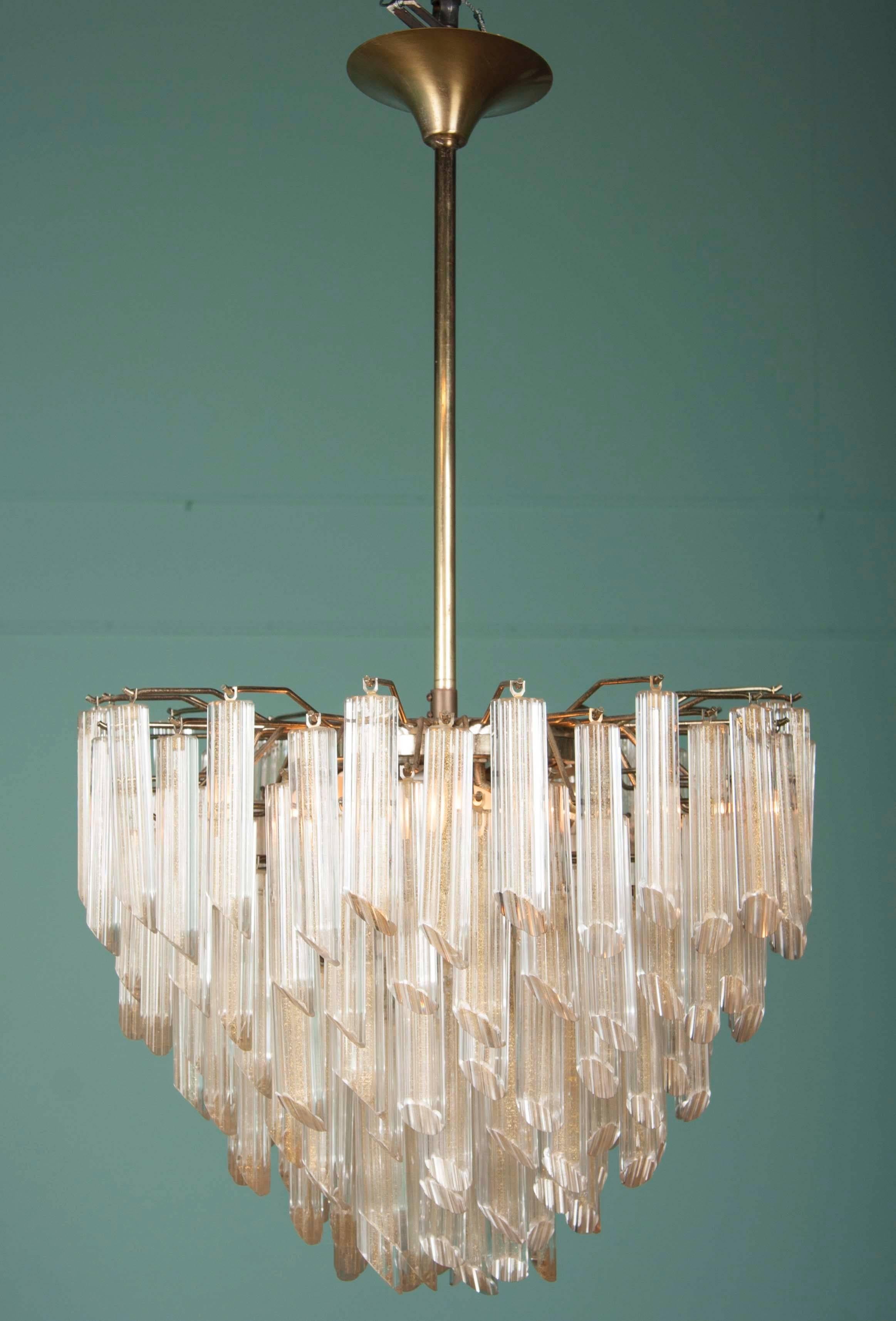 A magnificent Mid-Century Modern chandelier of tiered Murano glass prisms with gold inclusions by the Camer Glass Company.

Height of chandelier body : 17