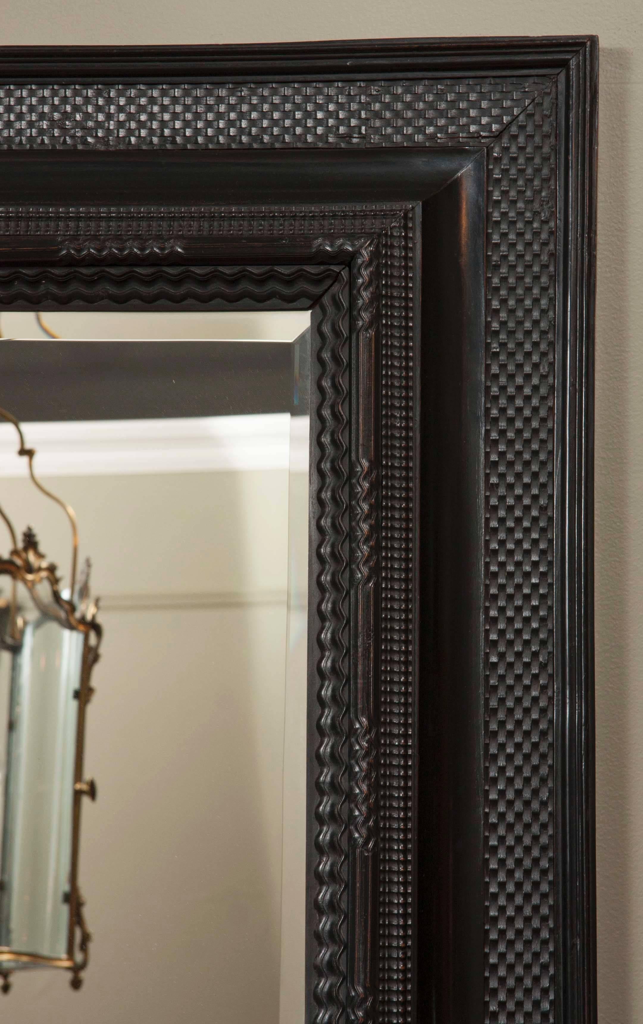 A large late 19th century Dutch ripple molded and ebonized mirror.