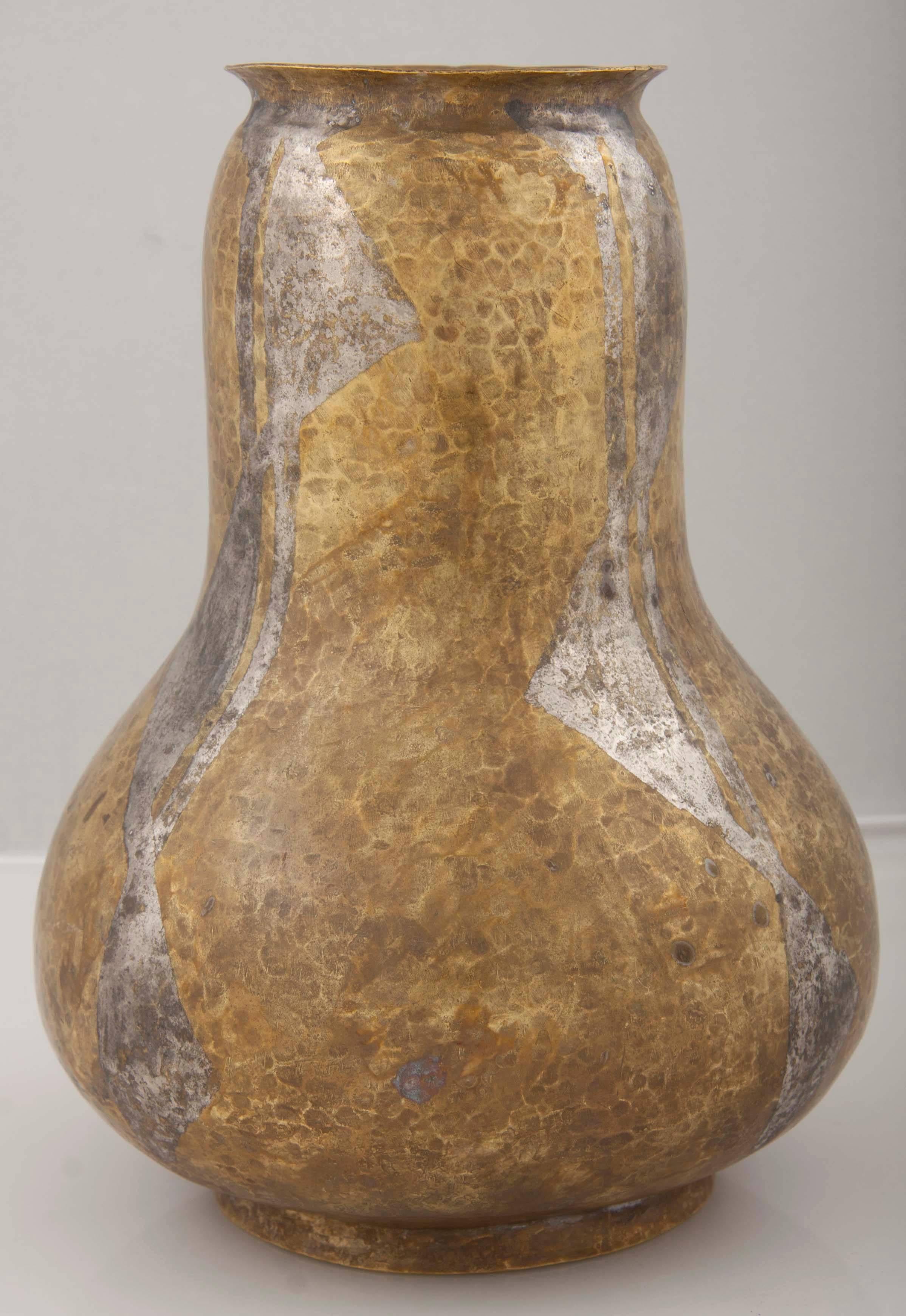 A beautifully patinated brass Dinanderie hammered vase. Made in France by Loys. Marked on underside.