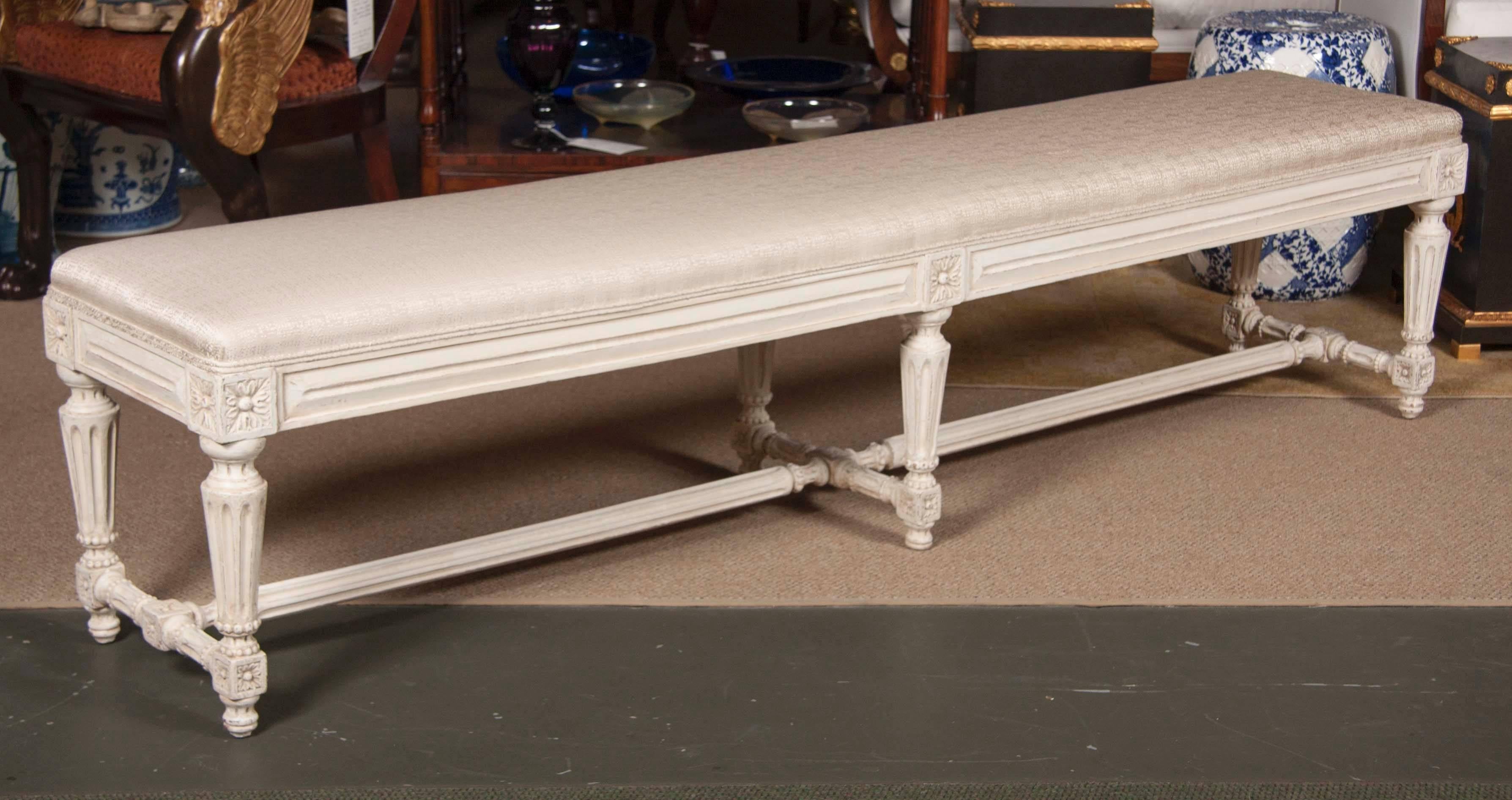 A late 19th century Louis XVI white painted banquette.