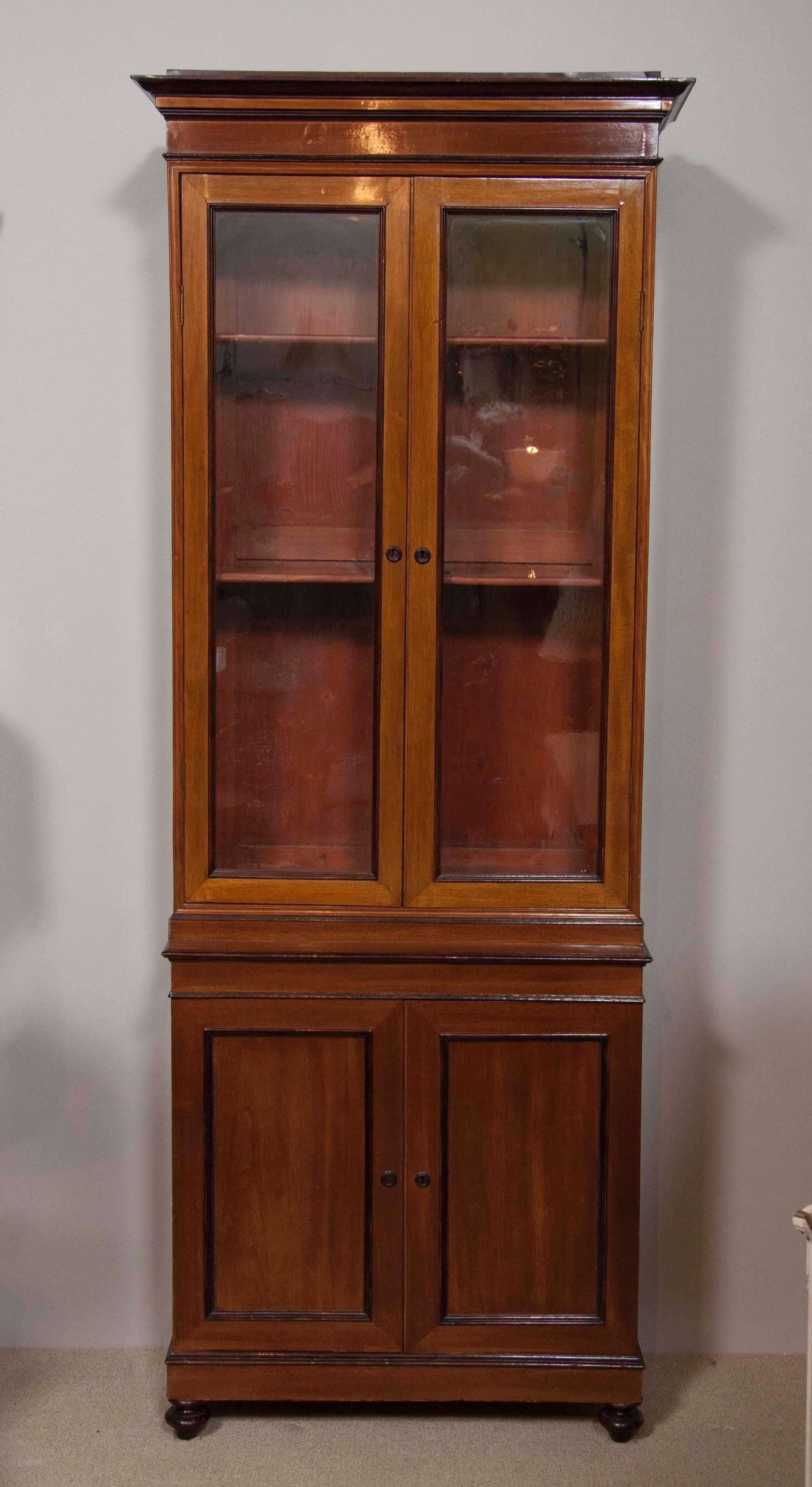A tall pair of 19th century Regency mahogany and ebonized cabinets.