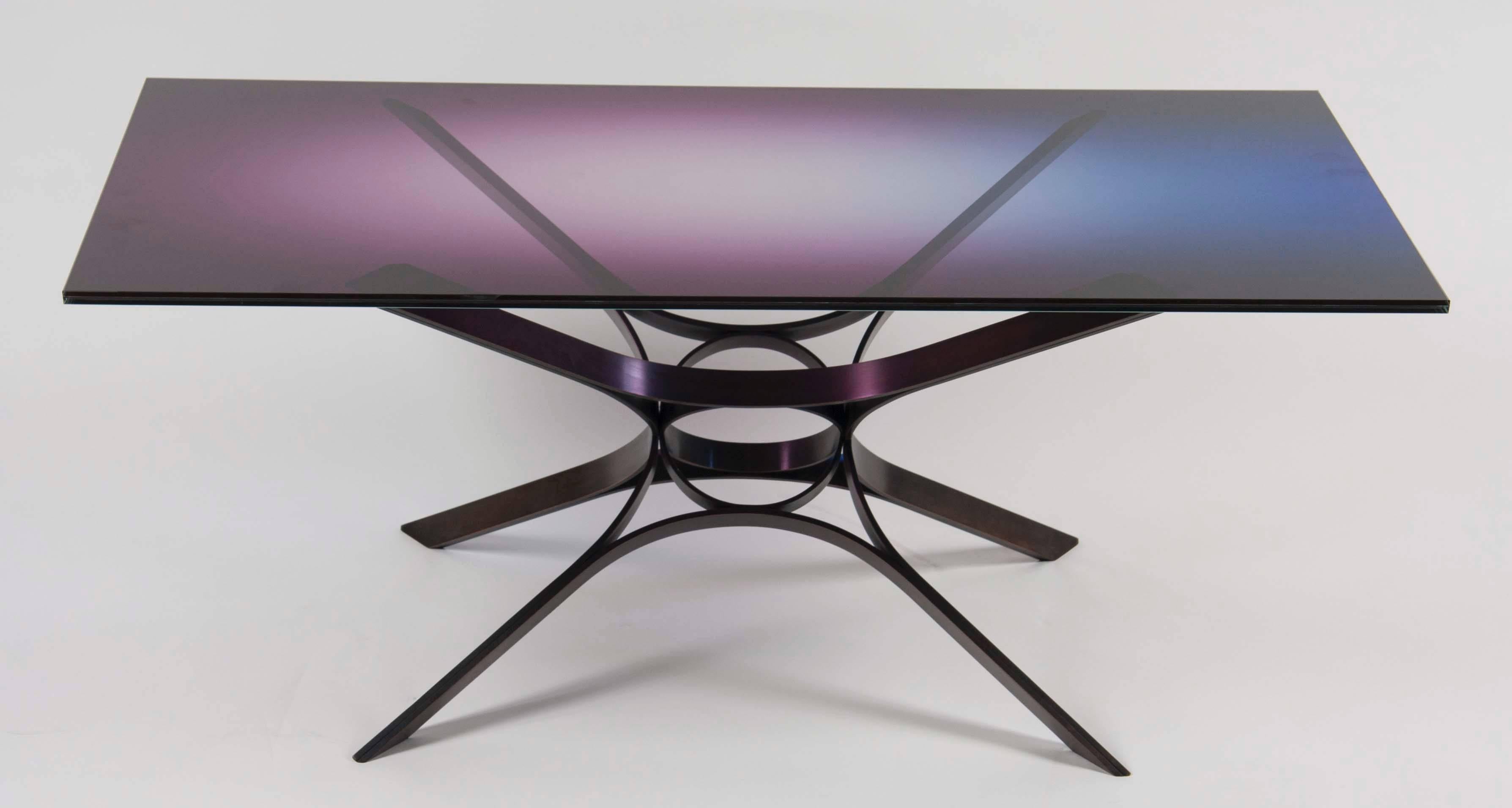 A glass top coffee table by Roger Sprunger for Dunbar with a multi color contemporary glass top.
