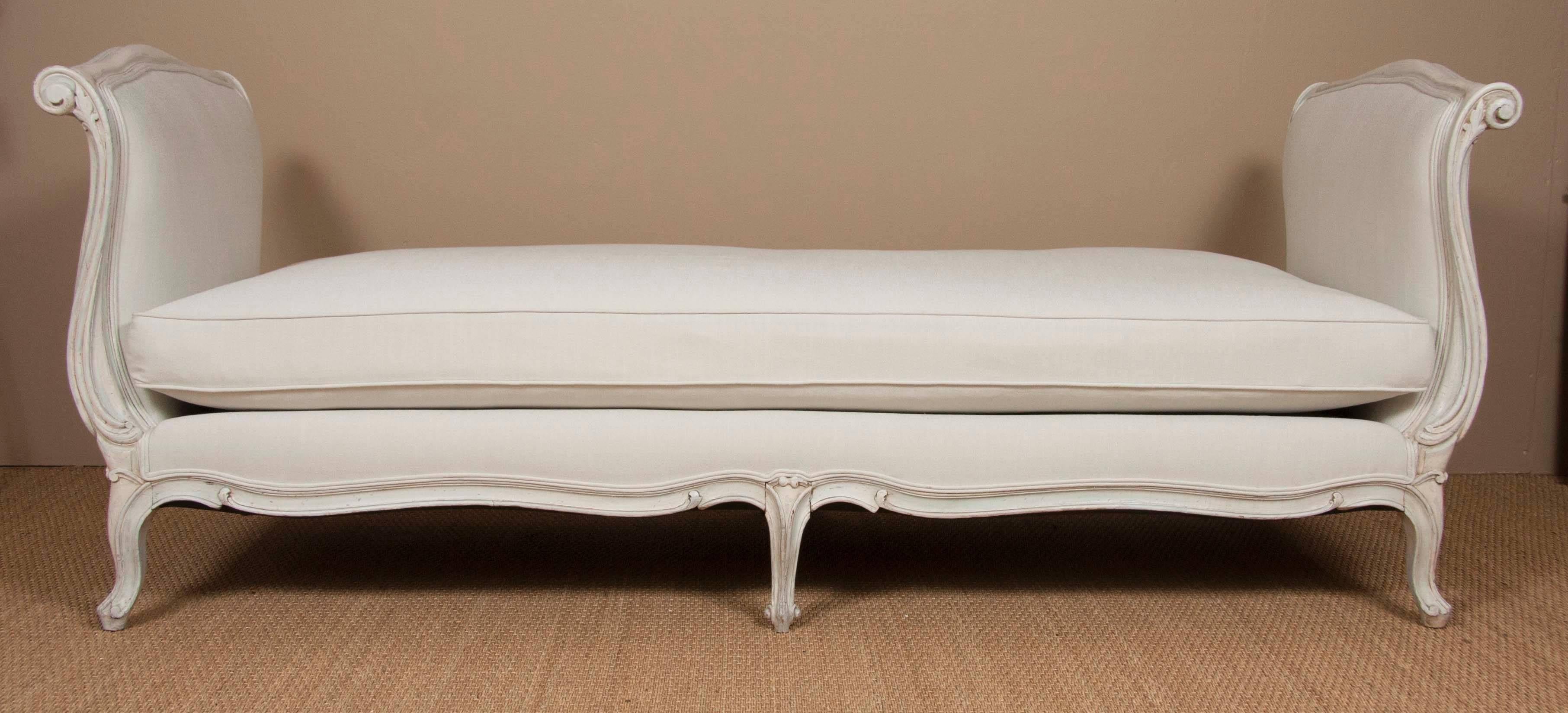 A Louis XV style carved and painted daybed; newly upholstered with all new cushions.