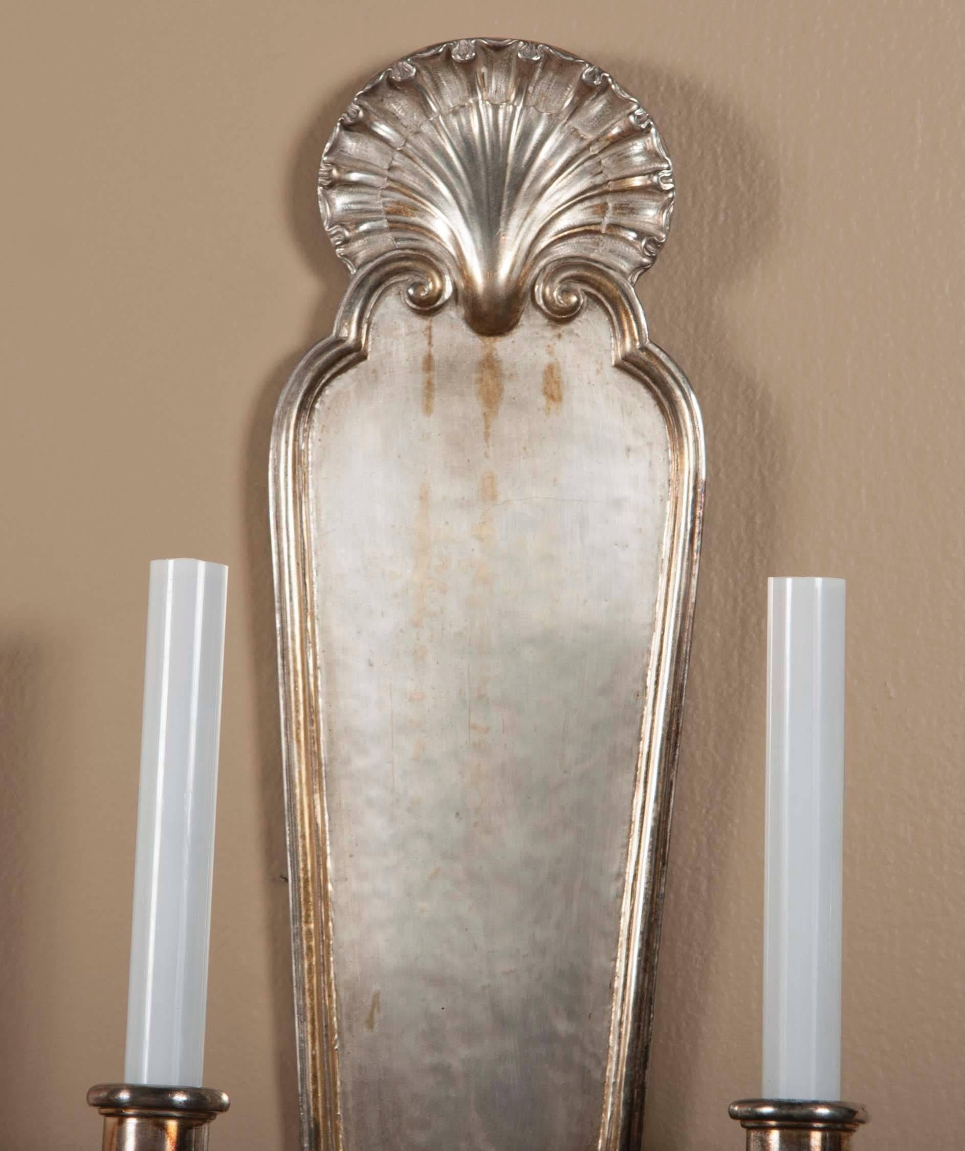 A pair of silver over bronze wall sconces by E.F Caldwell. One pair available.

Signed.