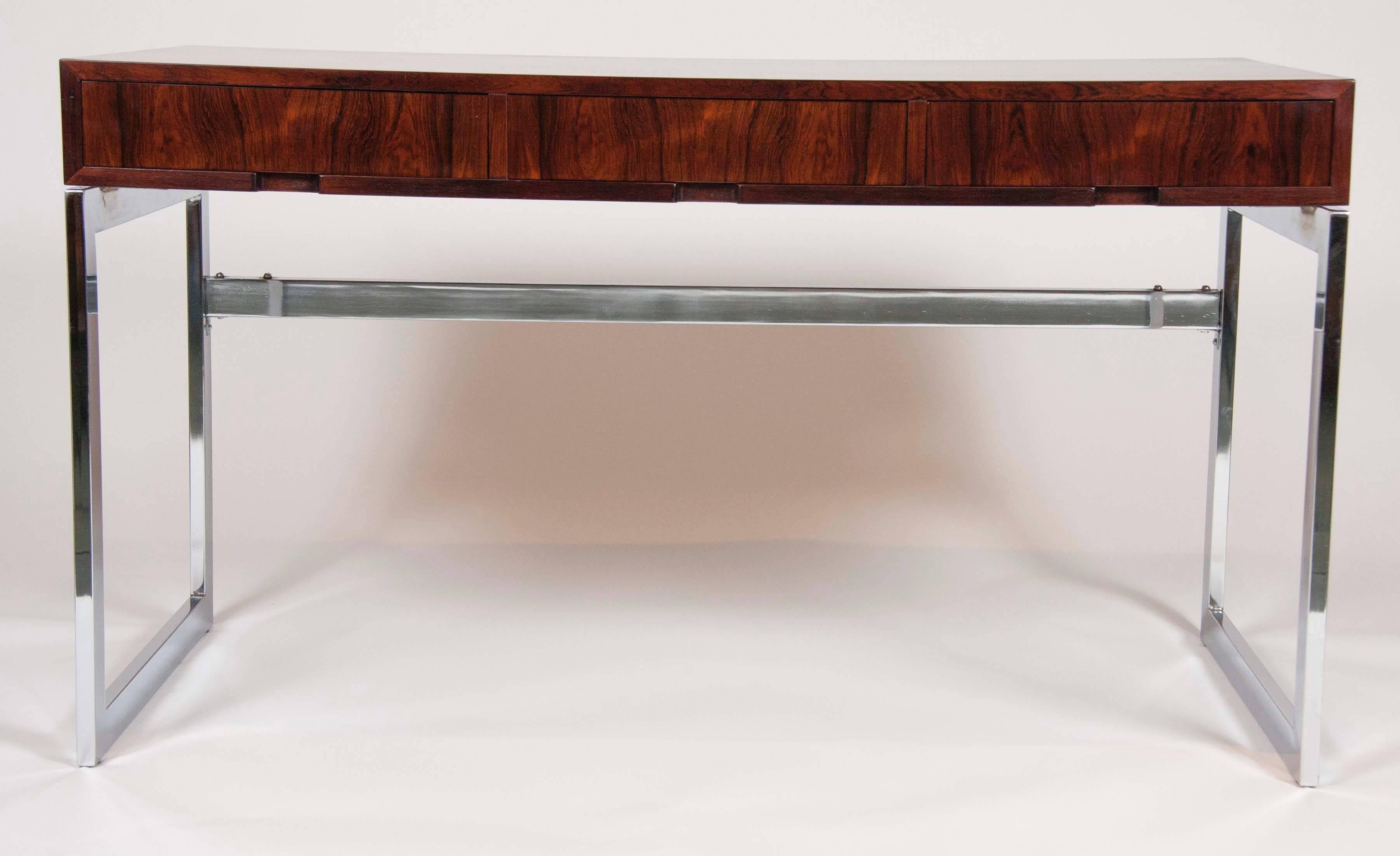 A very sleek three-drawer chrome with rosewood top desk in the style of Milo Baughman,
France.