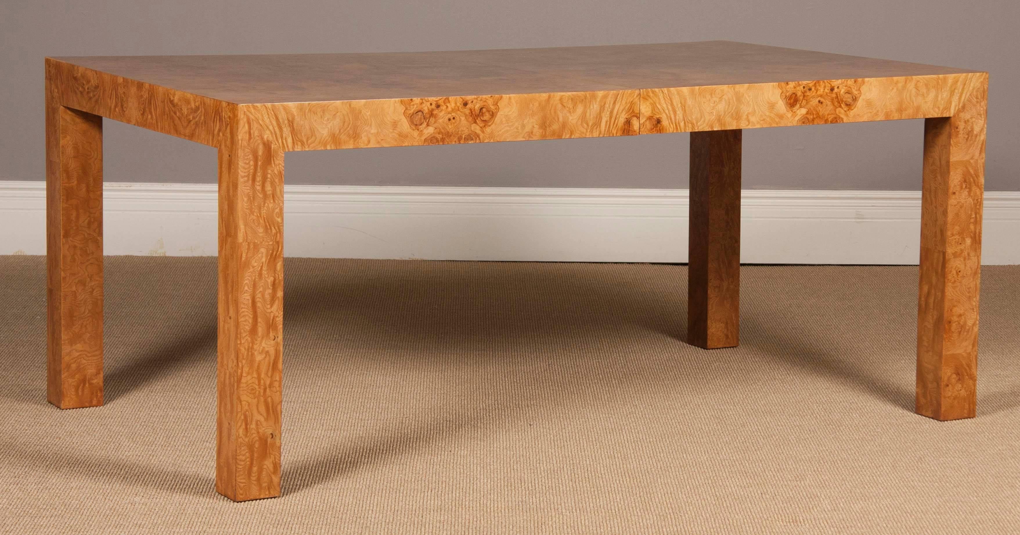 A Parsons style olivewood dining table designed by Milo Baughman. The table has 22
