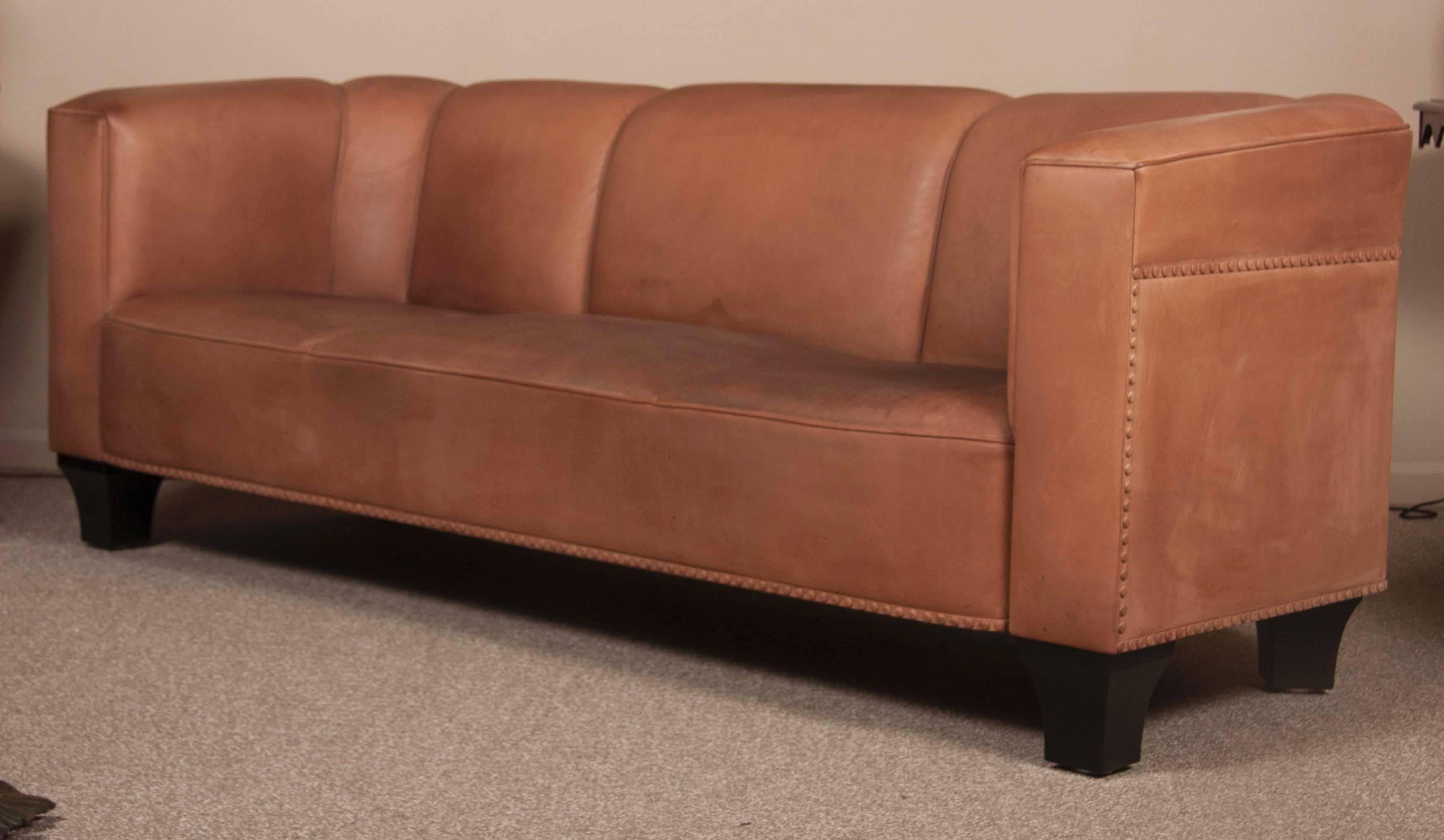 A contemporary brown leather three-seat sofa by Austrian designer Josef Hoffmann (1870-1956) with label 