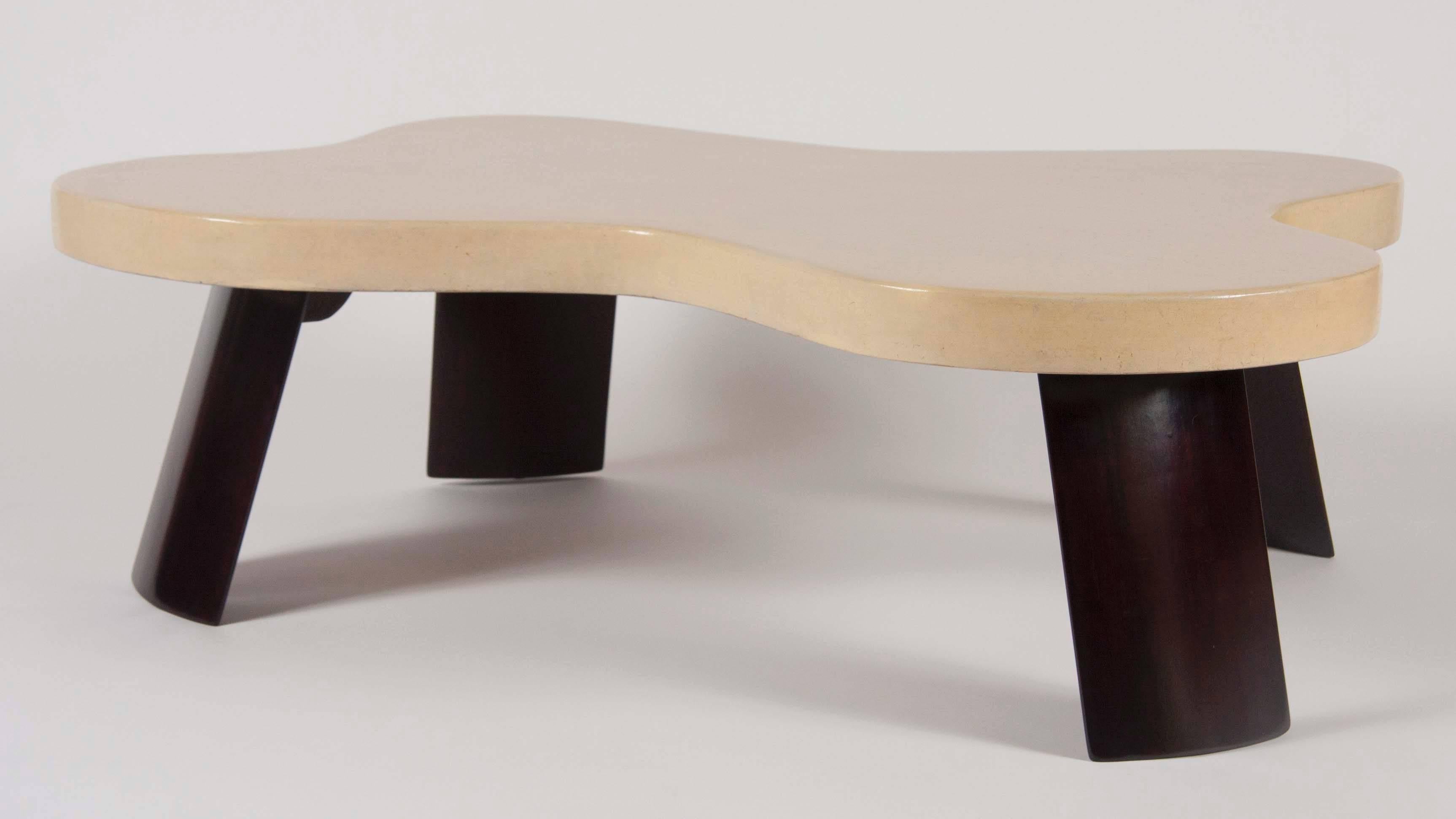An exceptional amorphic Amoeba table by Paul Frankl for Johnson Furniture having cork veneer top on four wooden legs.