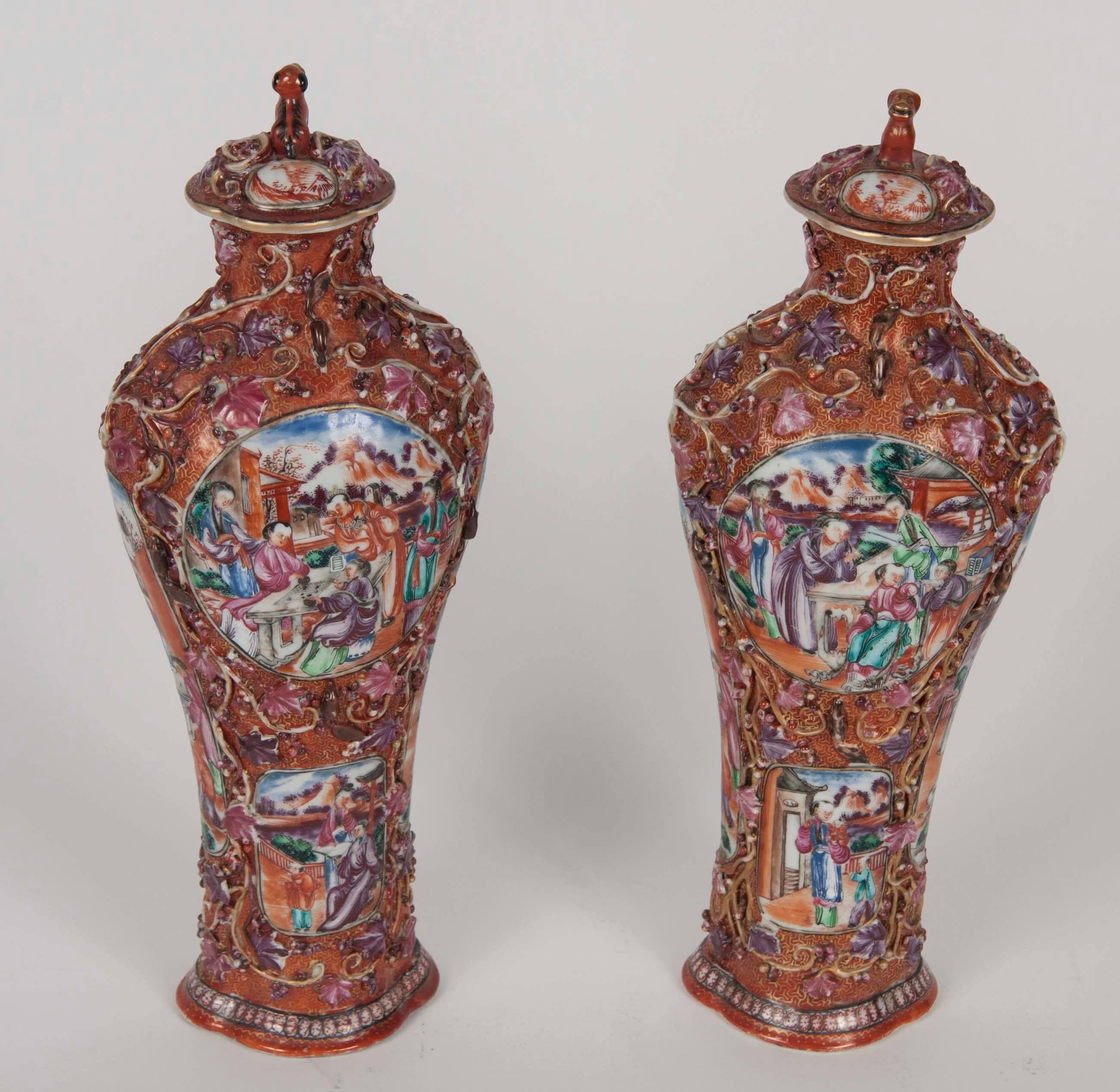 A fabulous pair of 18th century Chinese Rose Mandarin covered urns with extraordinary detail and raised decoration.