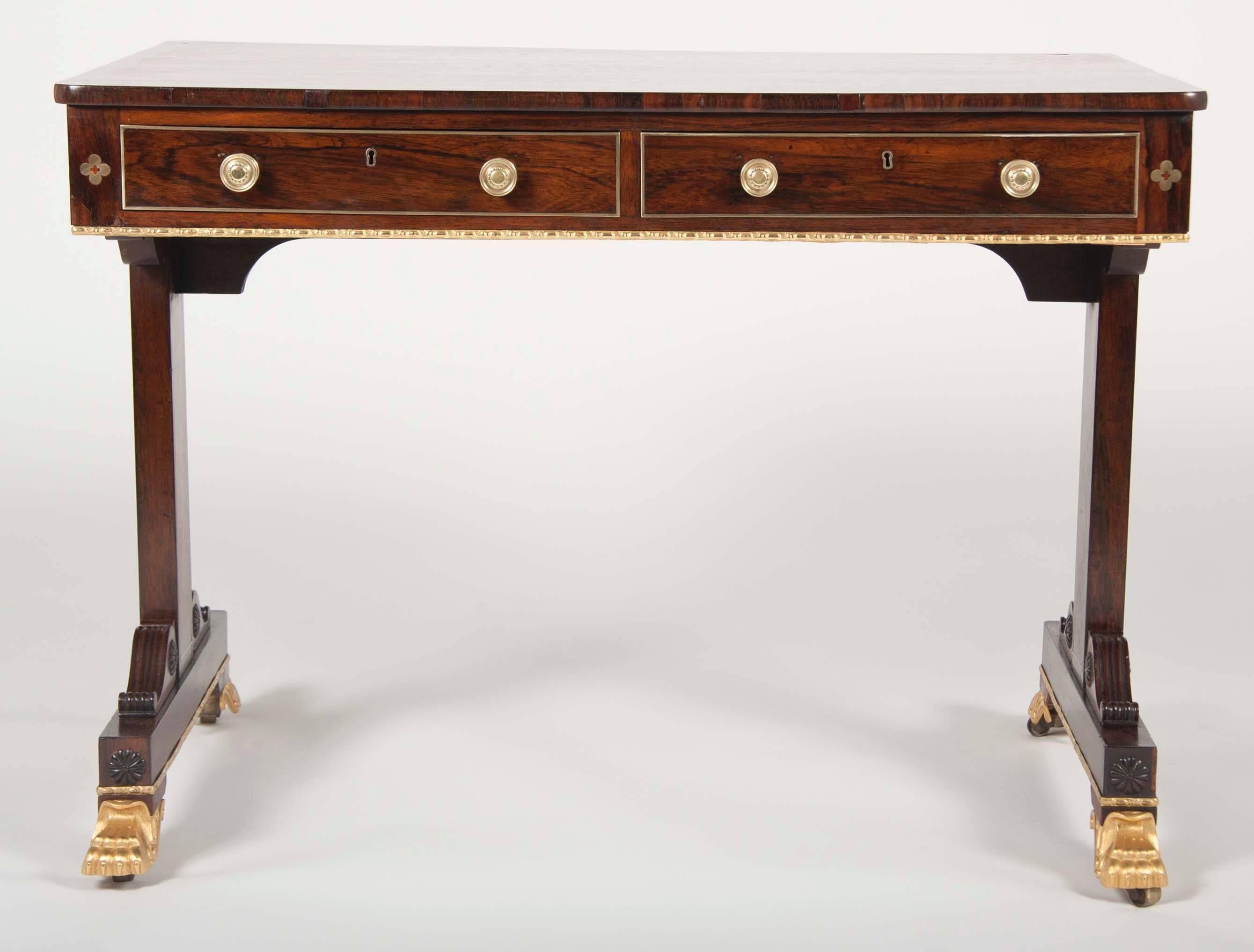A very fine English Regency Rosewood library table in rosewood with gilt metal and brass quatrefoil inlay. Attributed to Gillows.