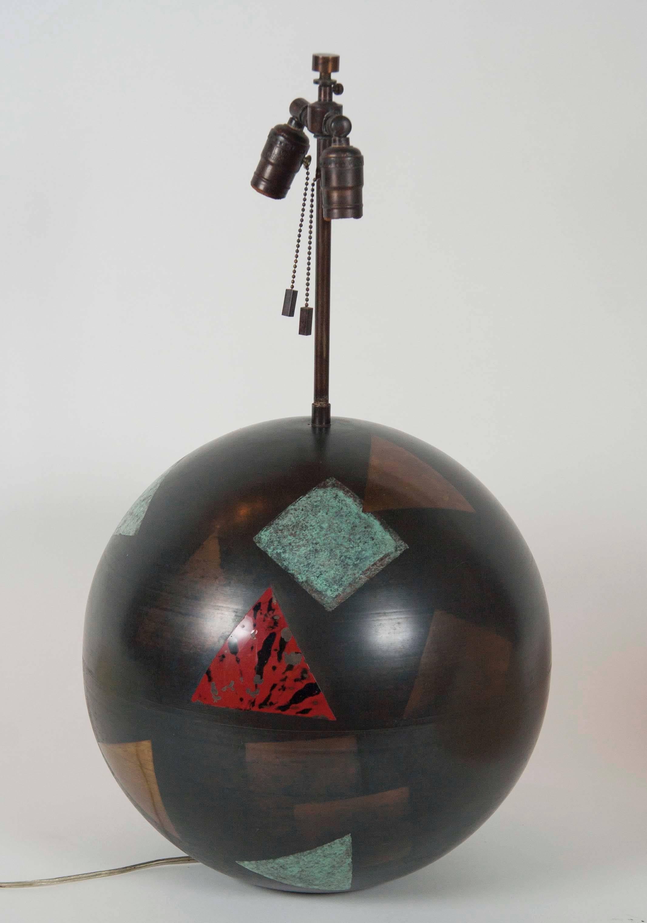 A bronze spherical lamp by Karl Springer with Dinanderie decoration and original shade. Some loss to Dinanderie decoration.