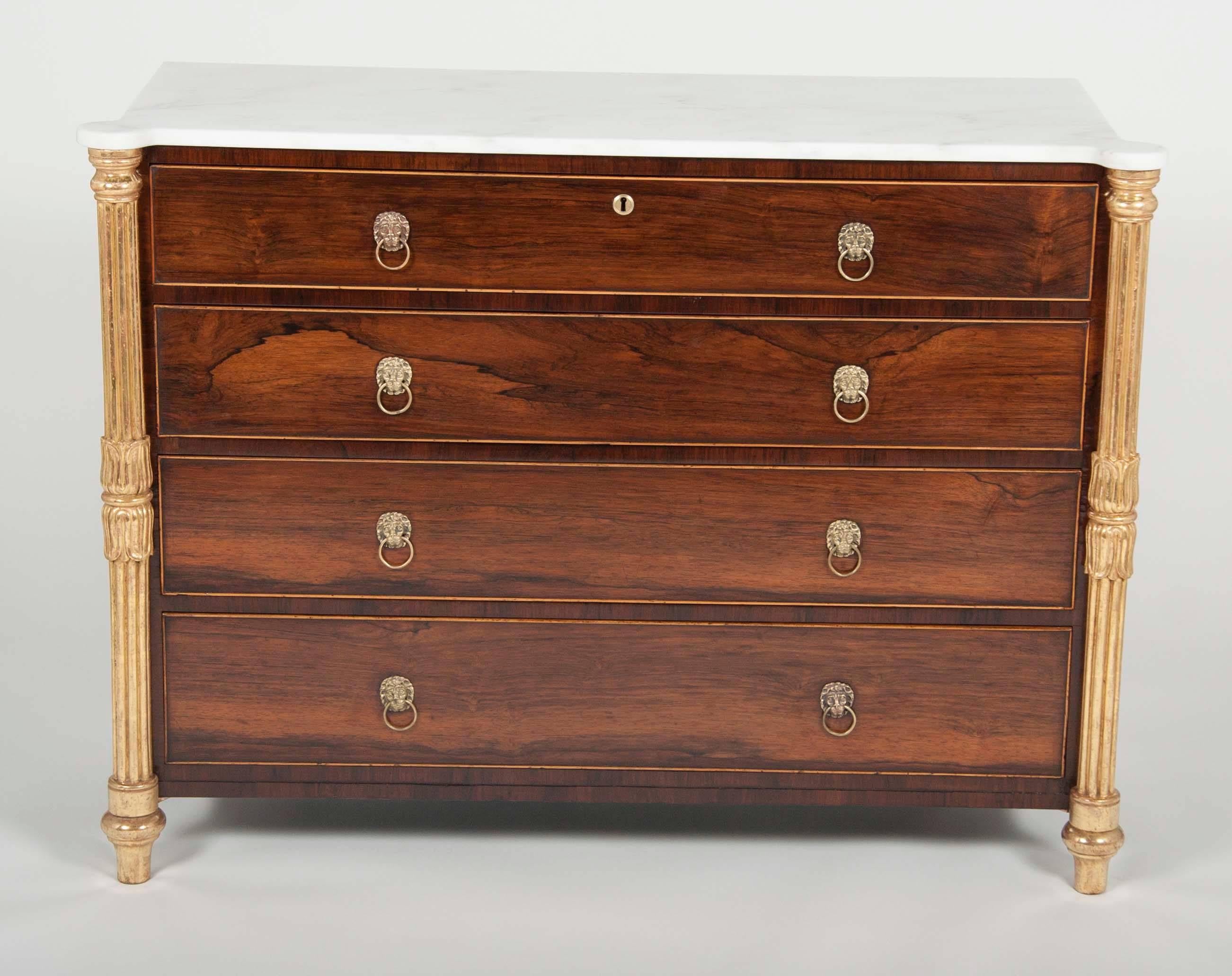 A beautiful George IV parcel-gilt rosewood chest of drawers with lotus flower carved columns and white marble top.
Newly restored or new top.