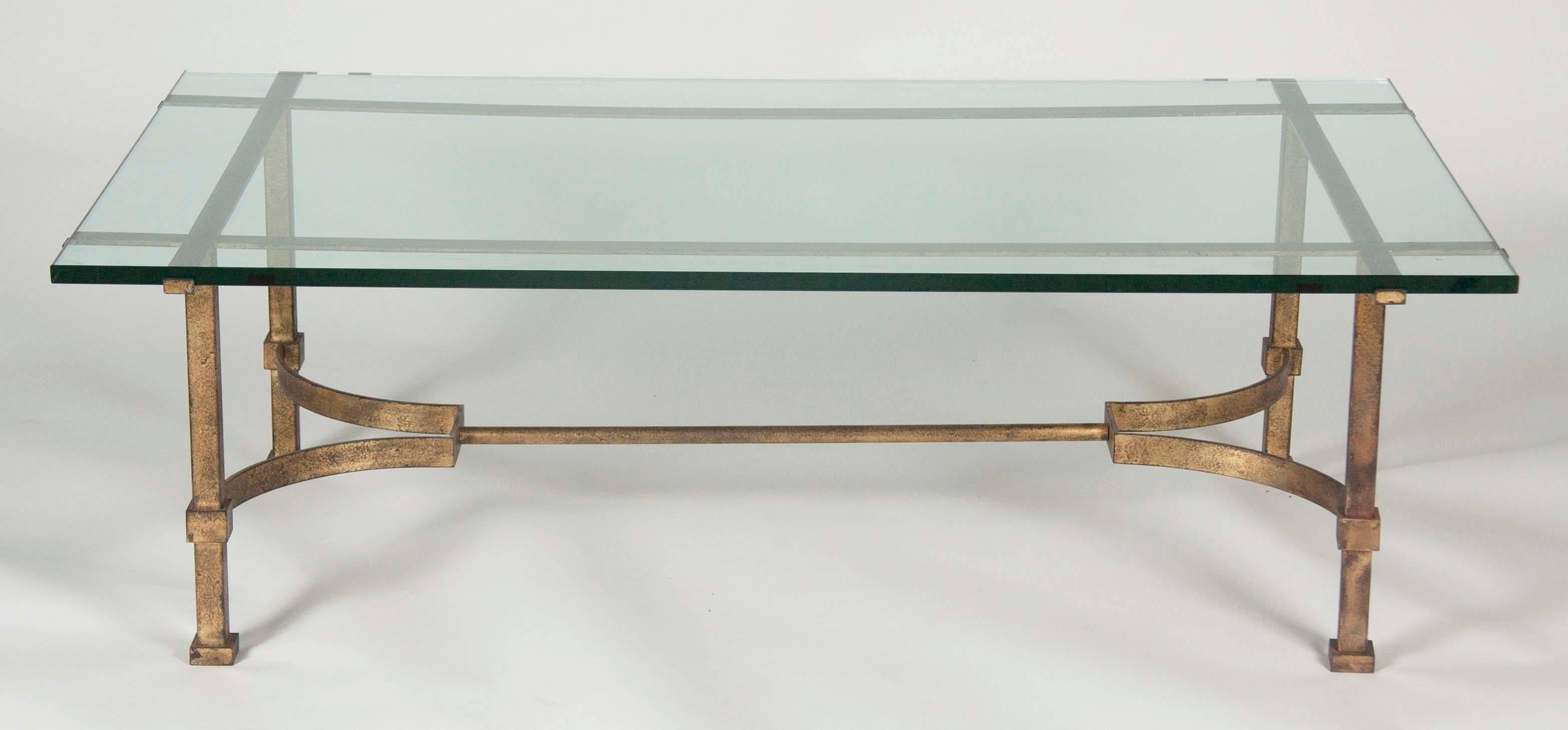 A gilt bronze and glass top coffee table attributed to Maison Jansen.