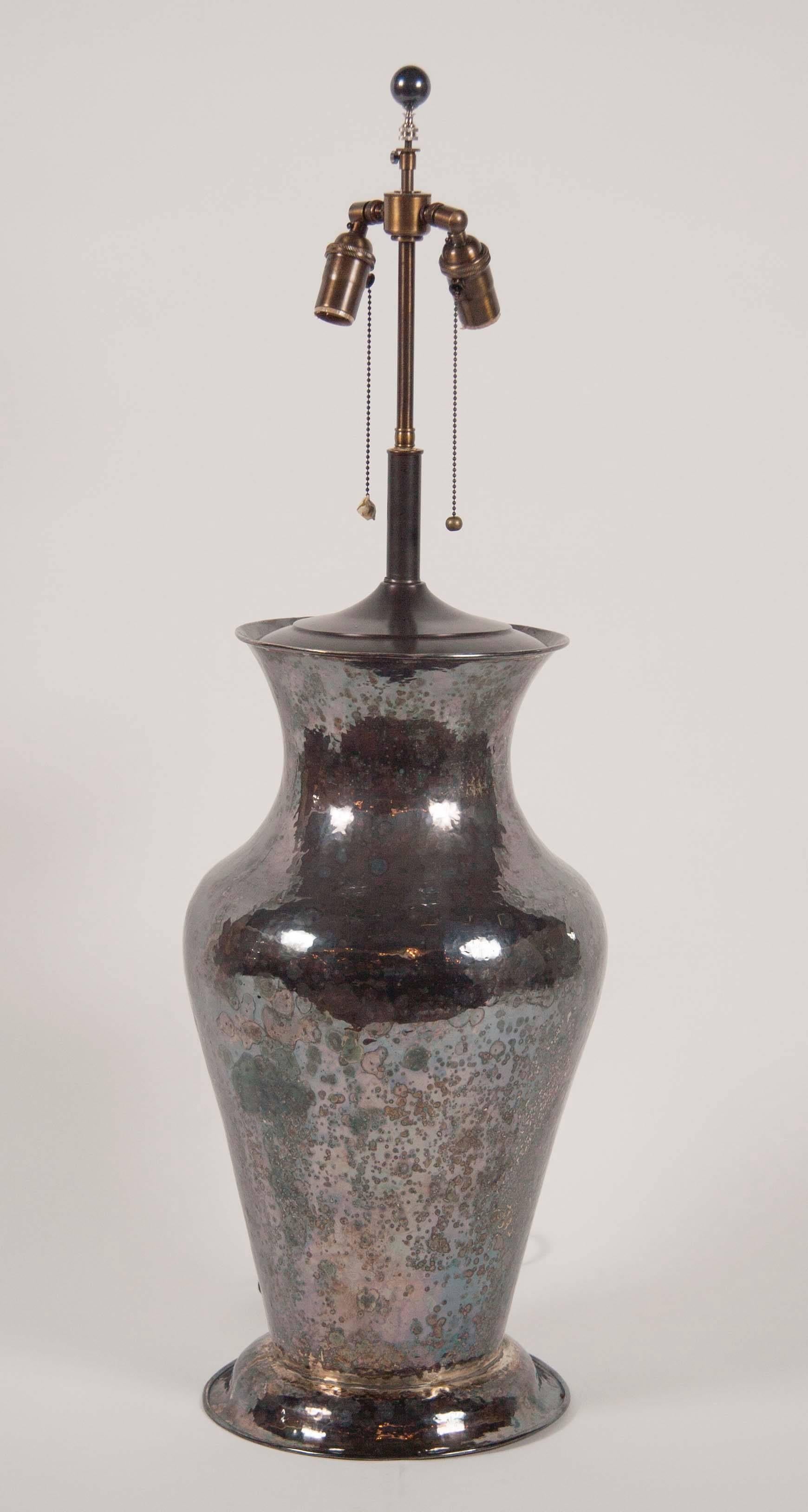 A handsome hammered silvered metal umbrella stand of now a lamp. Presumably American.
Measure: Height of stand: 23