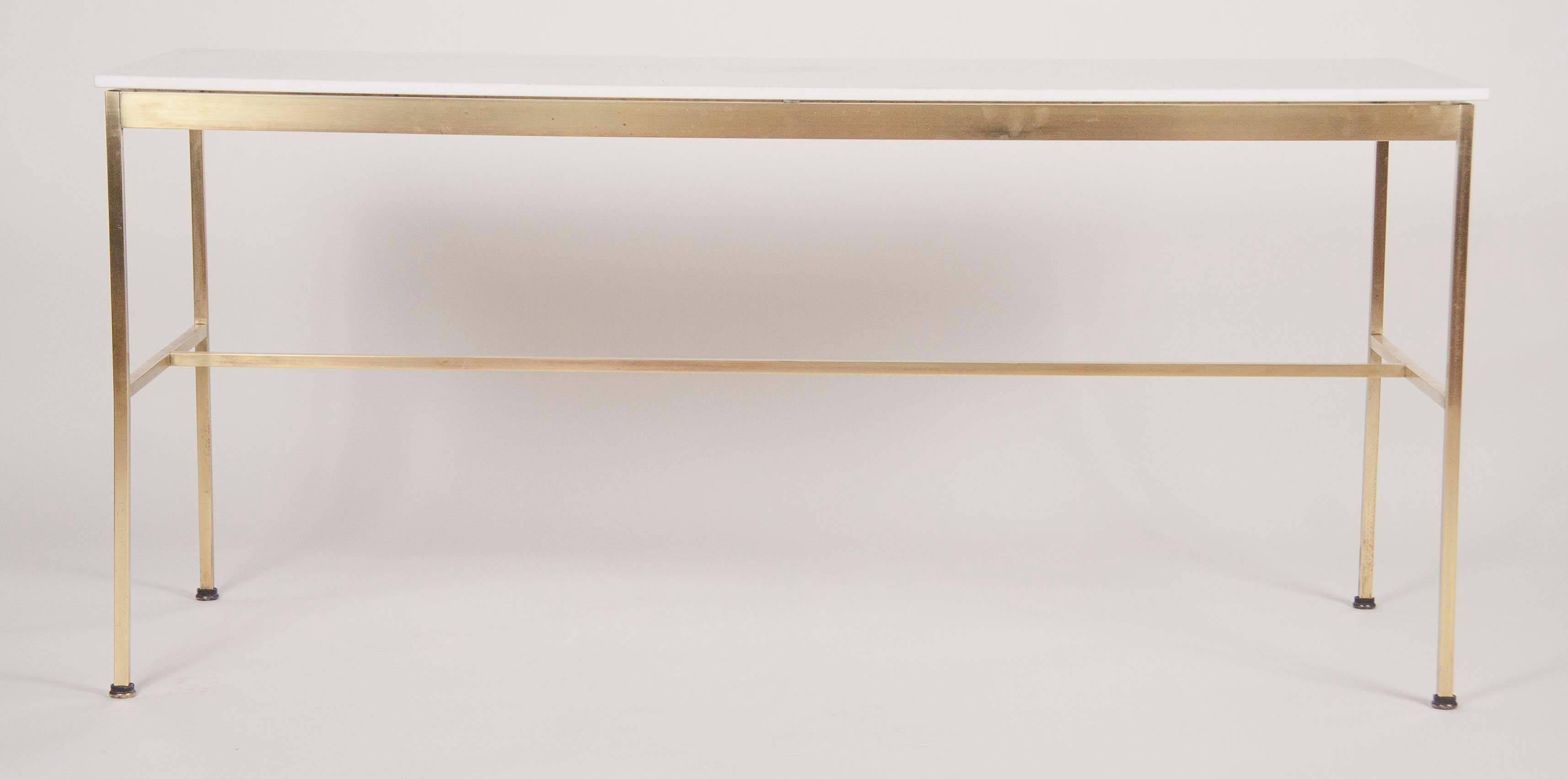 A brass console table designed by Paul McCobb for Calvin Furniture. The table has a virtrolite glass top, circa 1955.