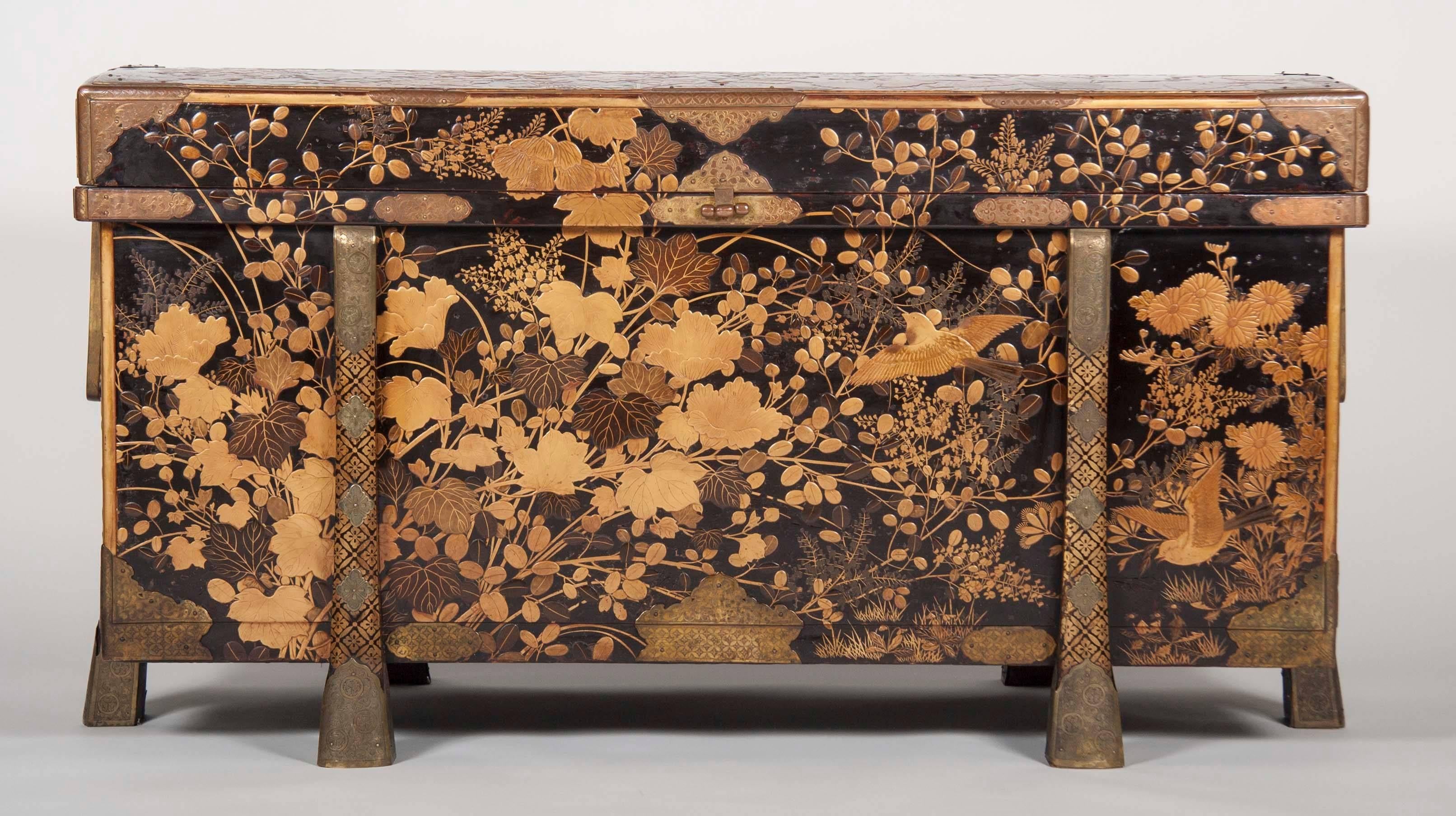 A stunning Large Japanese gilt and black lacquer Karabitsu chest with engraved bronze mounts. The Karabitsu is a rectangular lidded chest raised on four legs. The name implies a foreign origin for this elegant and functional form, used in Japan