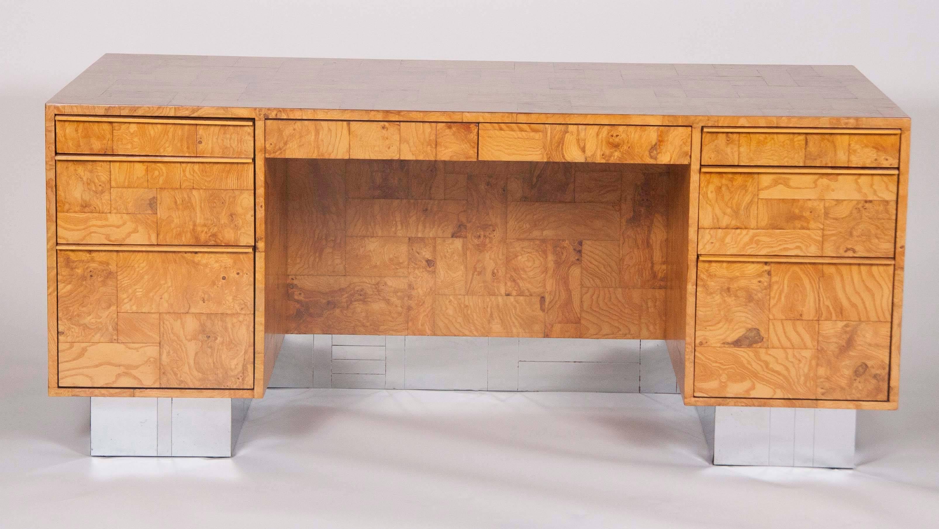 A signed olivewood veneer desk rising from a metal tiled cityscape base. This desk was designed by repute specifically for a customer by Paul Evans, circa 1978.