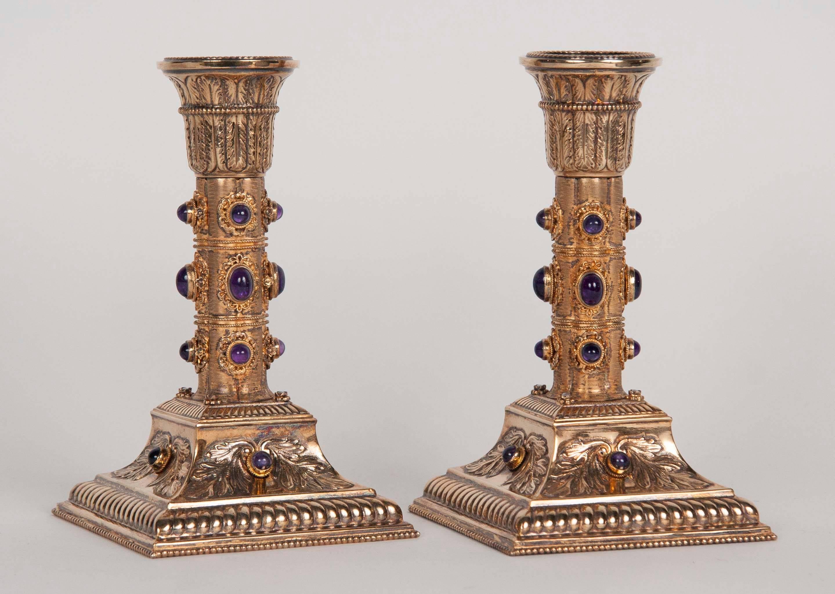 A stunning pair of gilt silver Viennese candlesticks with amethyst cabochons and inset pearls.