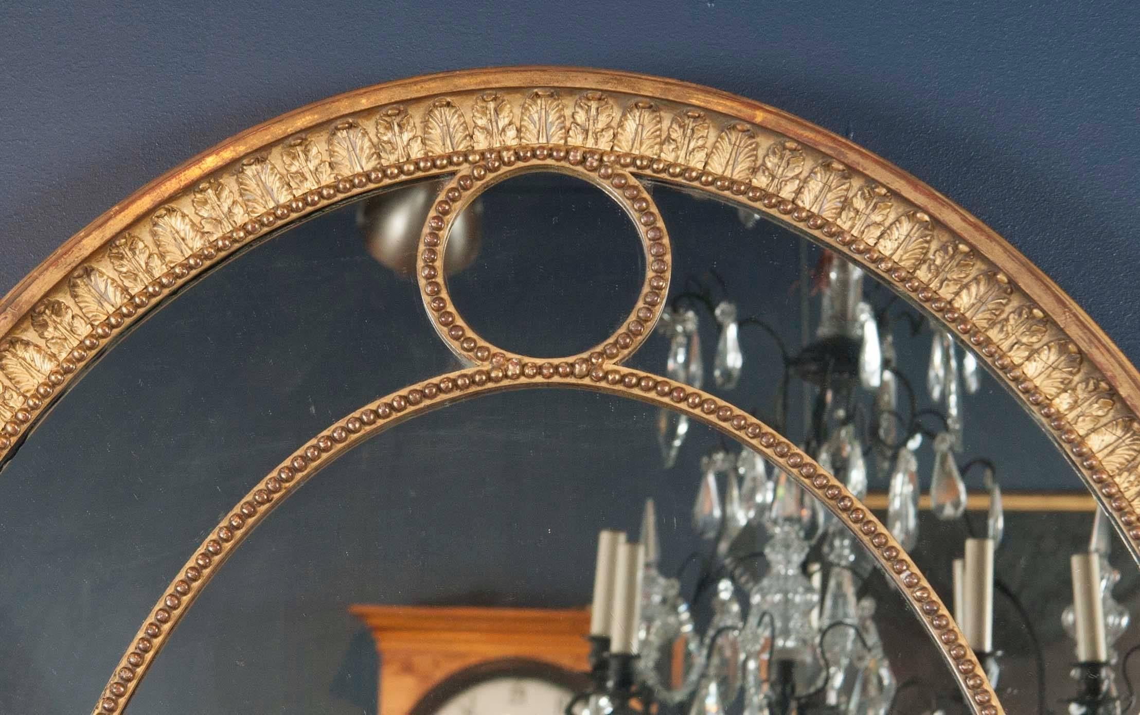 Carved Pair of English Oval Giltwood Mirrors