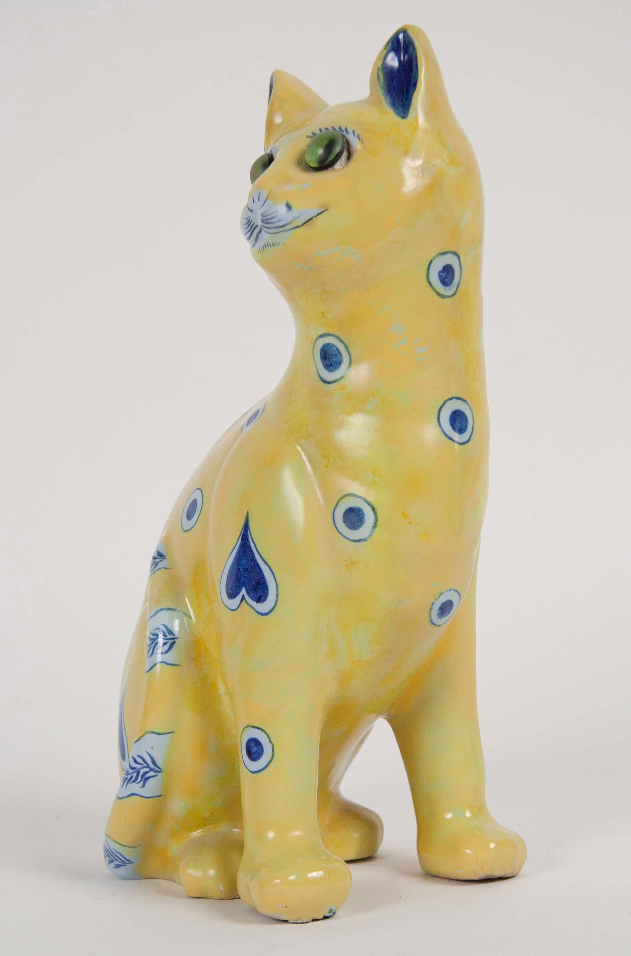 A yellow painted ceramic cat by Emile Galle. Signed on bottom.