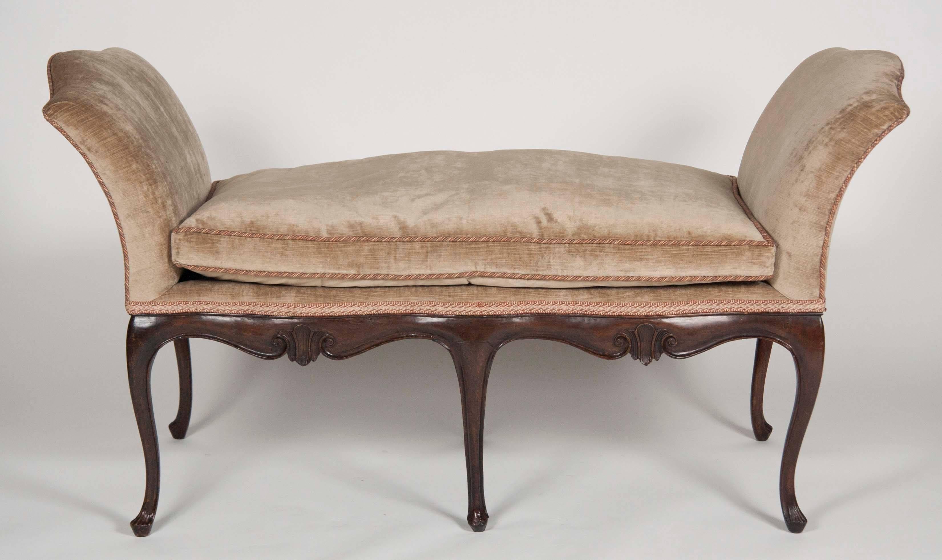 French walnut window seat with scrolled arm supports and a serpentine shaped seat raised on six cabriole legs. Upholstered in silk velvet. Loose cushion.
Finished on both sides.


 
