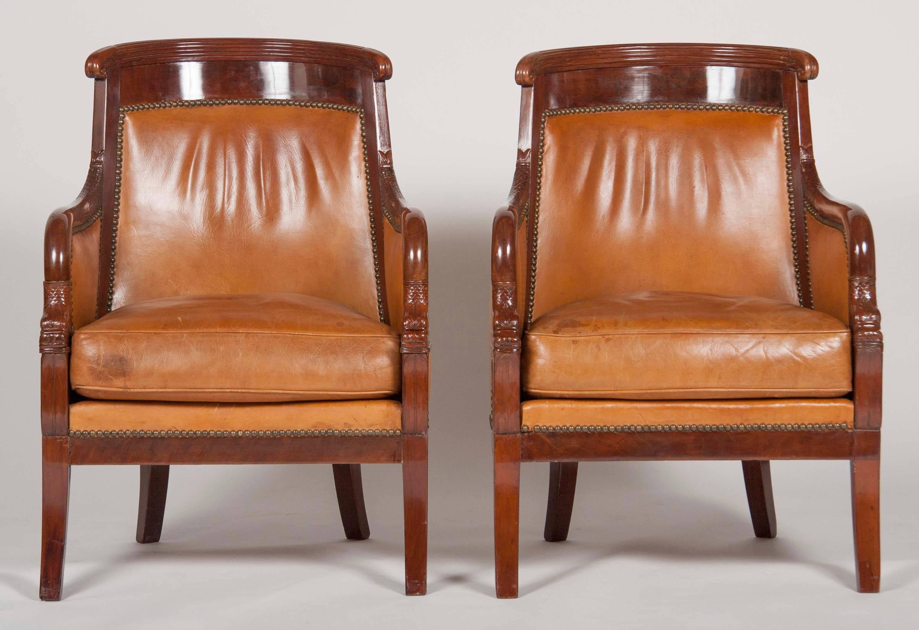 A matched pair of mahogany Louis Philippe bergères upholstered in leather.