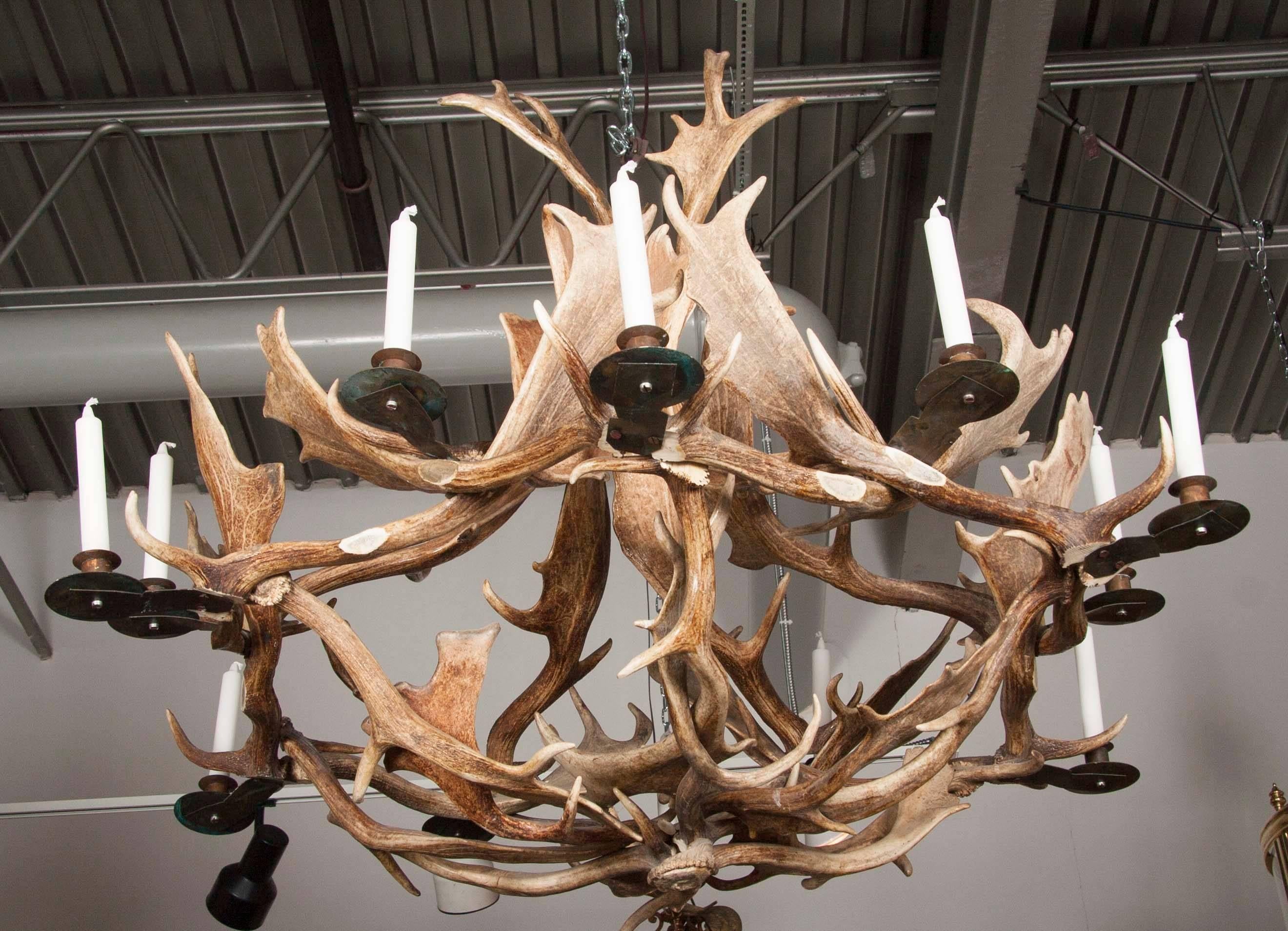 A twelve-light European fallow deer antler chandelier by Stan Hughes for Guinevere . Unelectrified.

Signed: S.G.H