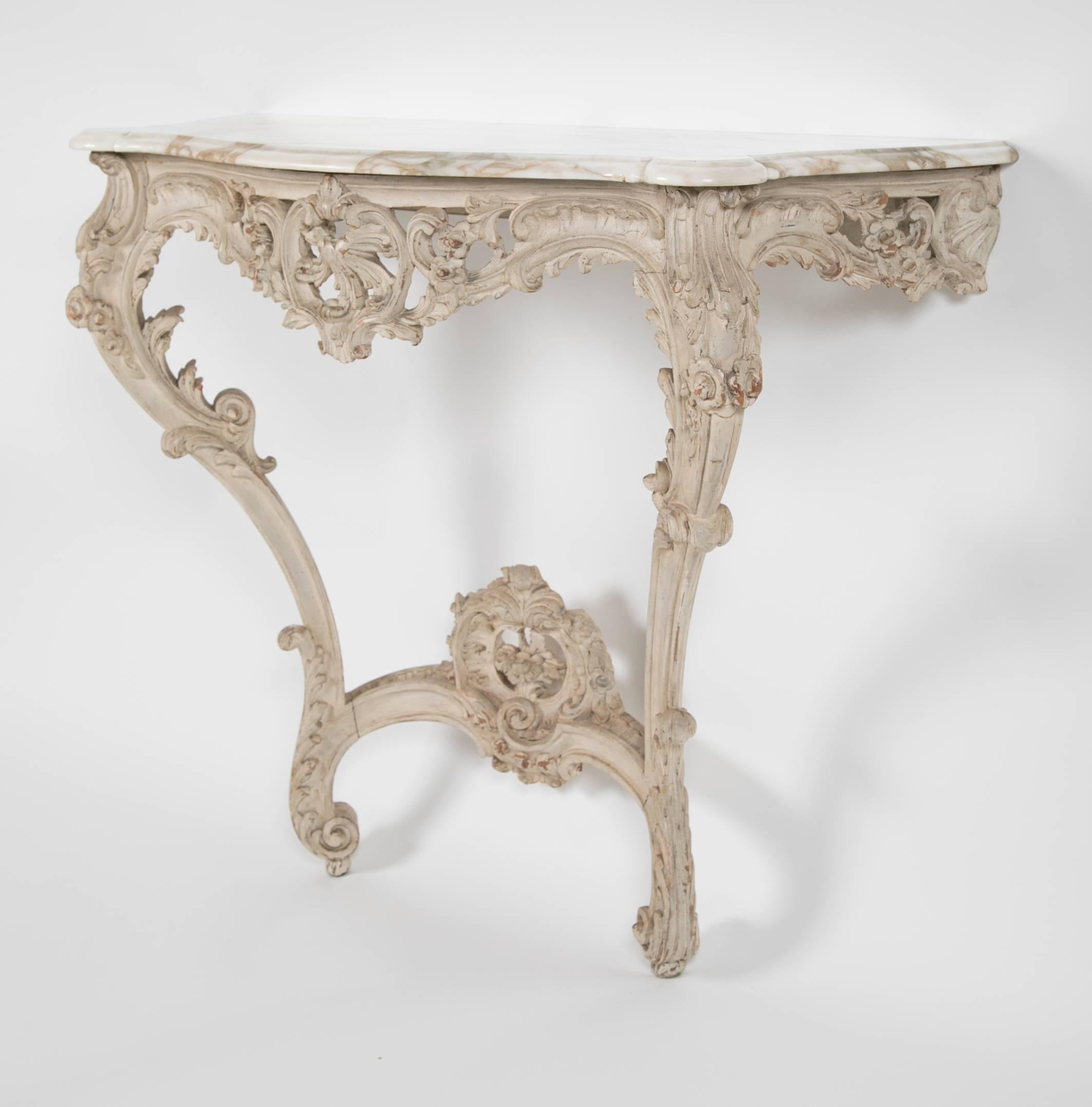 A late 19th century French pier table with painted carved wood frame, scrolling in form, and marble top.
