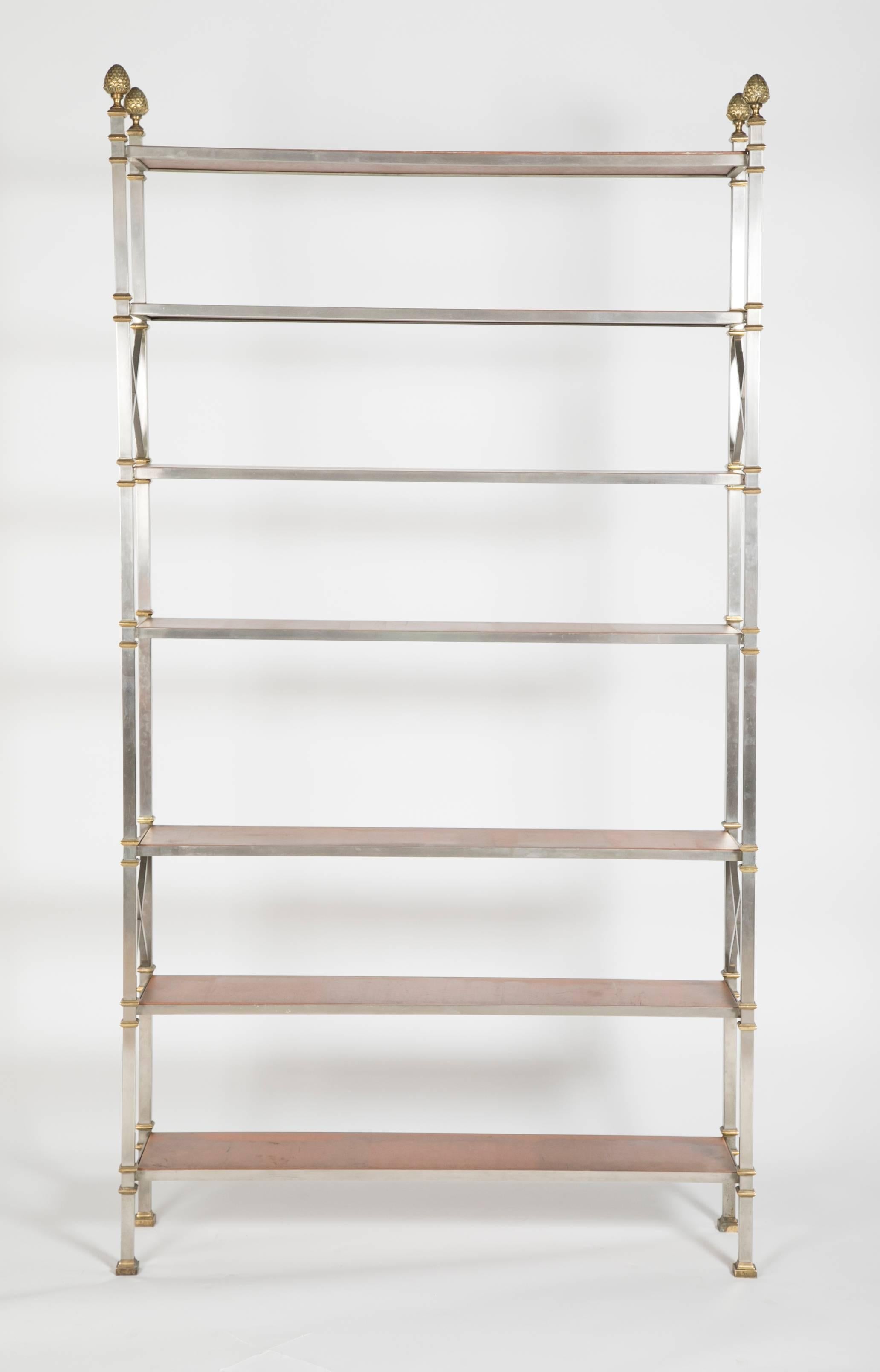 A pair of steel and bronze etageres with seven faux leather shelves in the manner of Maison Jansen.