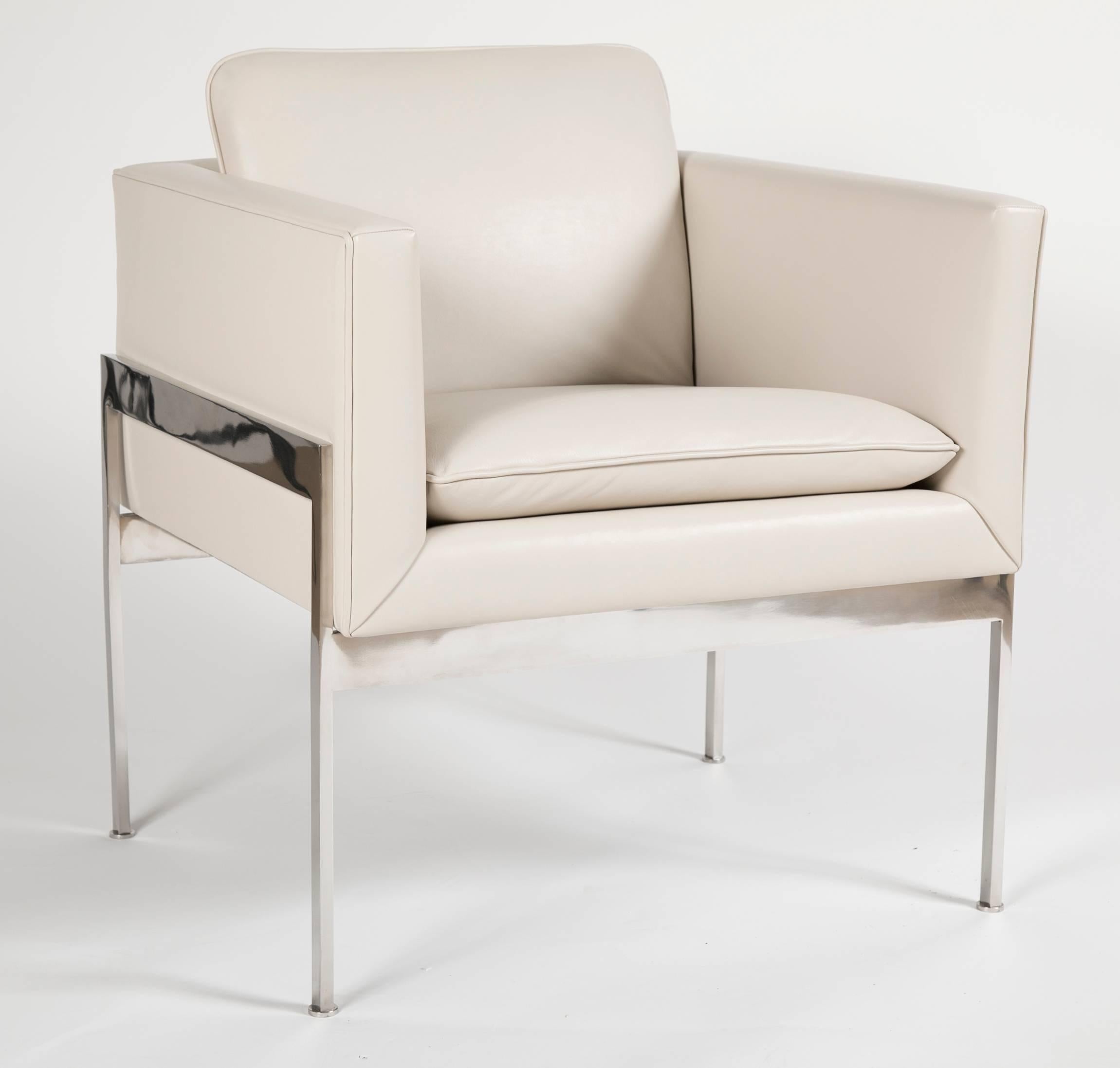 A cube chair newly covered in cream Sorensen leather. The frame is made of solid chrome-plated metal terminating on 1/4