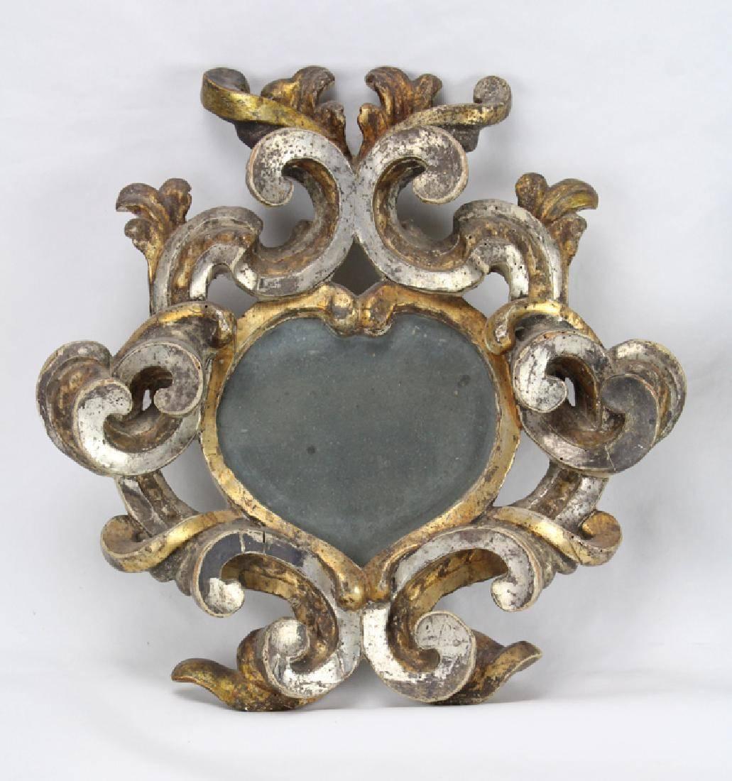 An unusual pair of 18th century Italian wood carved and heart shaped silver and giltwood Baroque mirrors. 


 