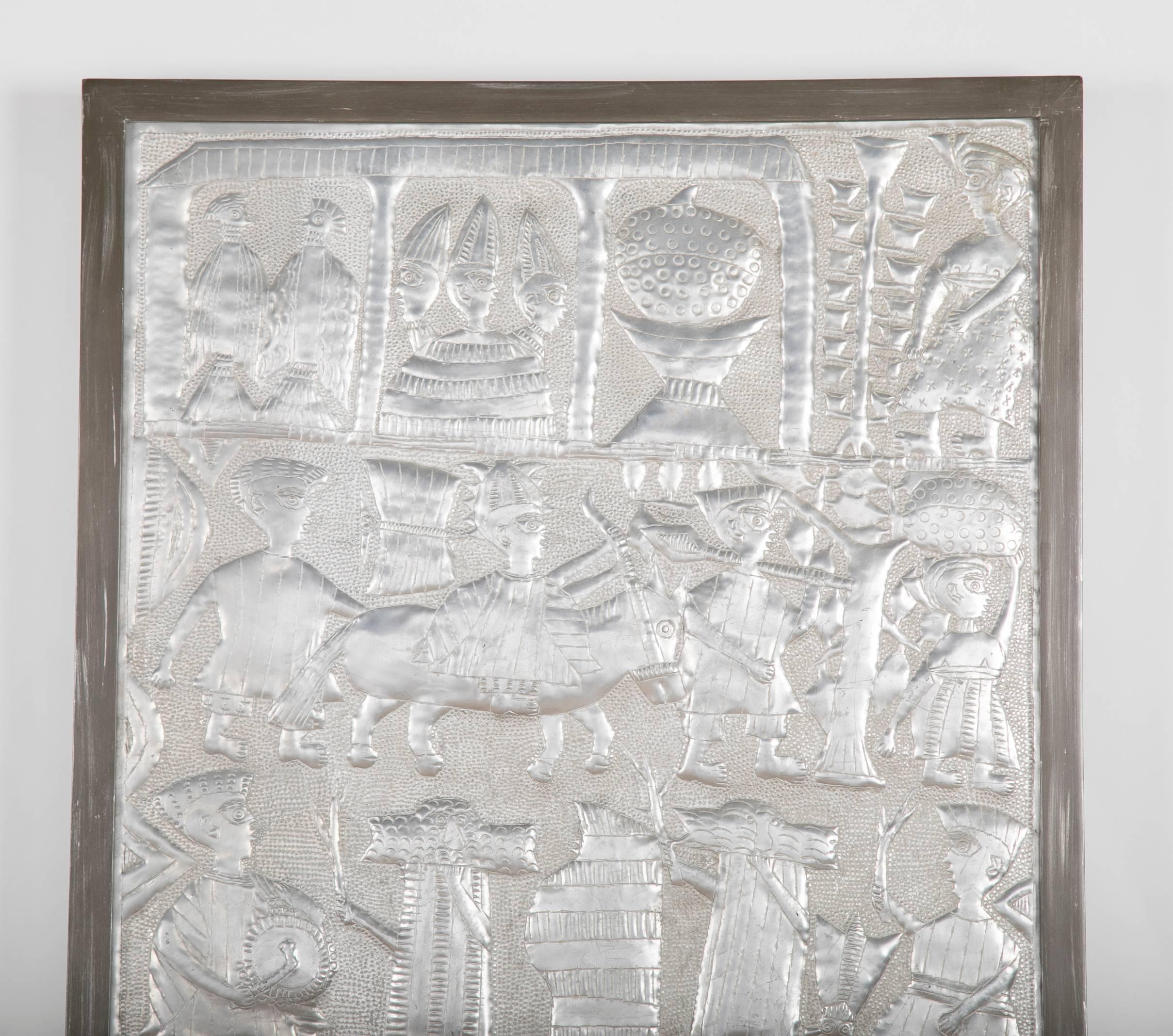 A hammered aluminum plaque of Yoruba tribal scenes by Nigerian artist Asiru Olatunde 
(1918-1993). One of two pieces available by Olatunde.