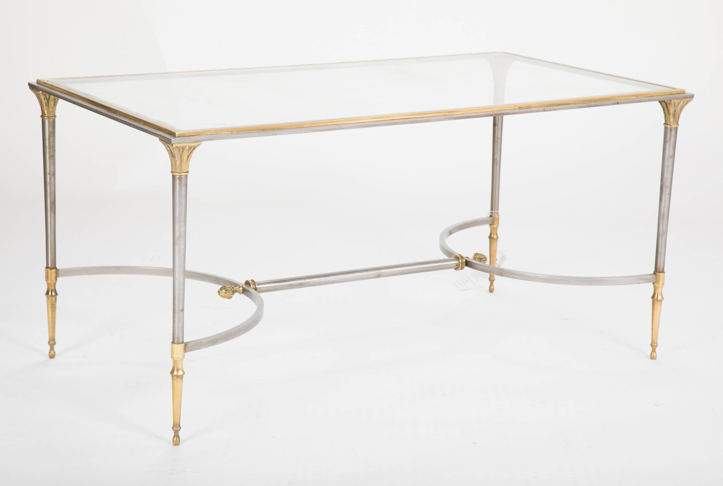 A steel and gilt bronze coffee table by Maison Charles with glass top.