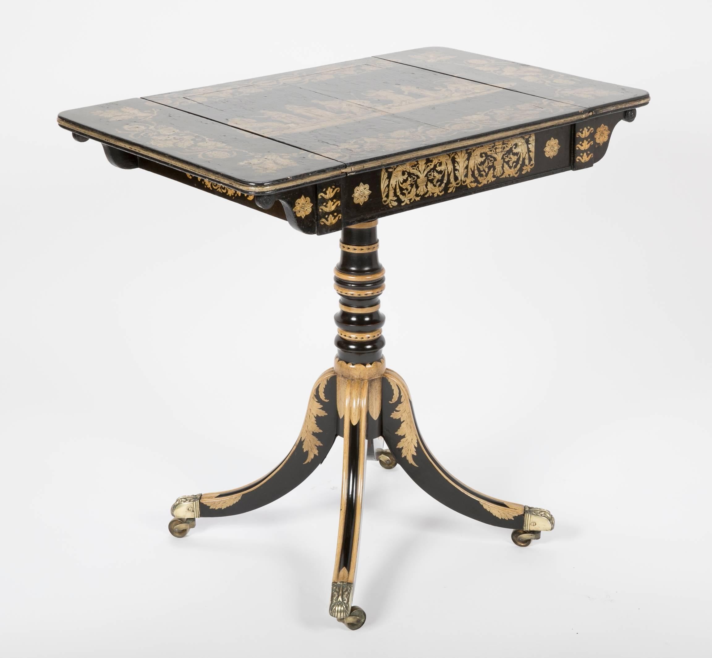 Penwork games table with pedestal on four legs and wheeled feet, English, circa 1810.