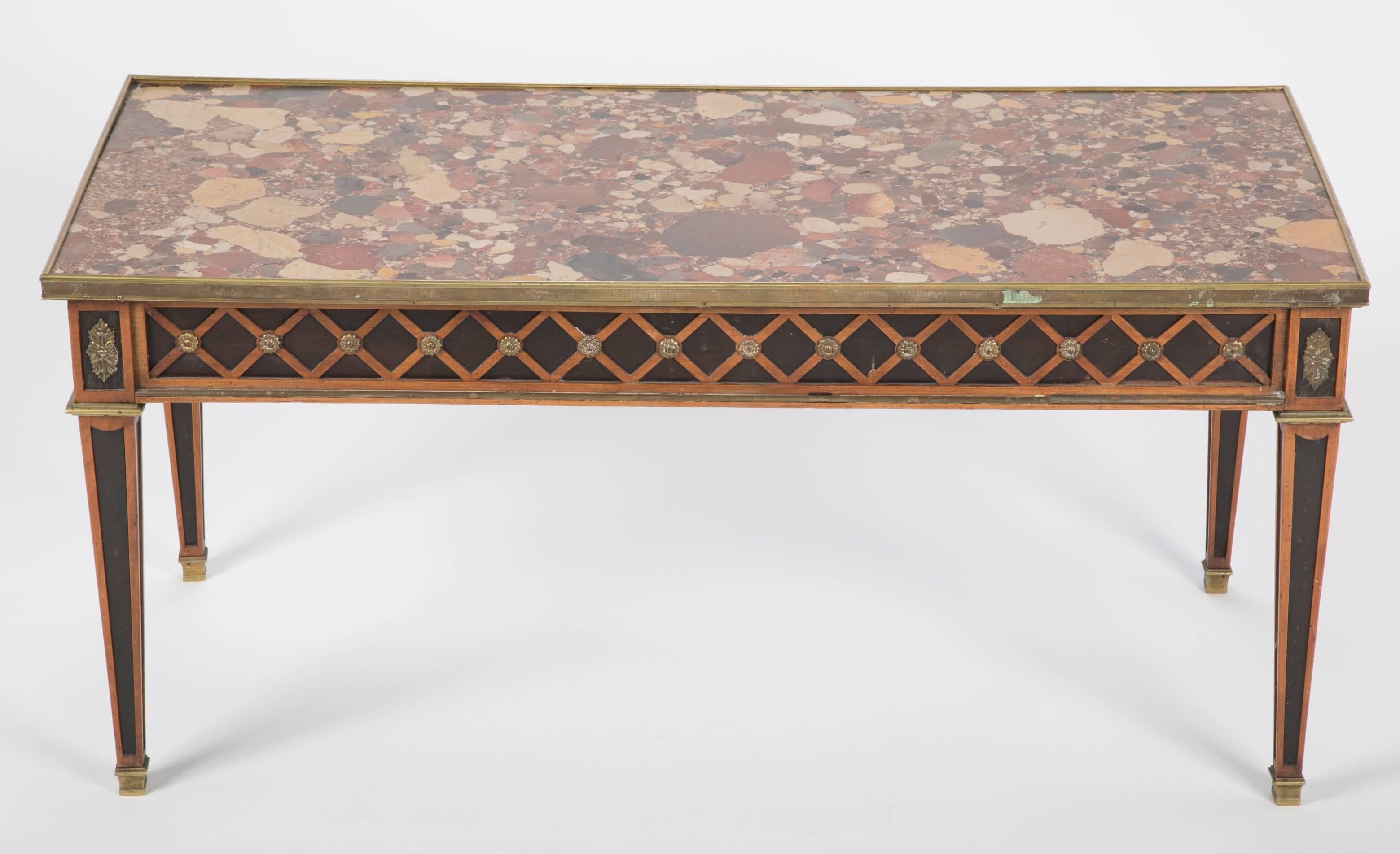 Elegant French Louis XVI style coffee table custom made by Jansen with bronze contour and ornaments, very fine brèche d’Alep marble top and lozenge pattern marquetry  

Provenance: documented 998 Fifth Avenue, NY residence.


