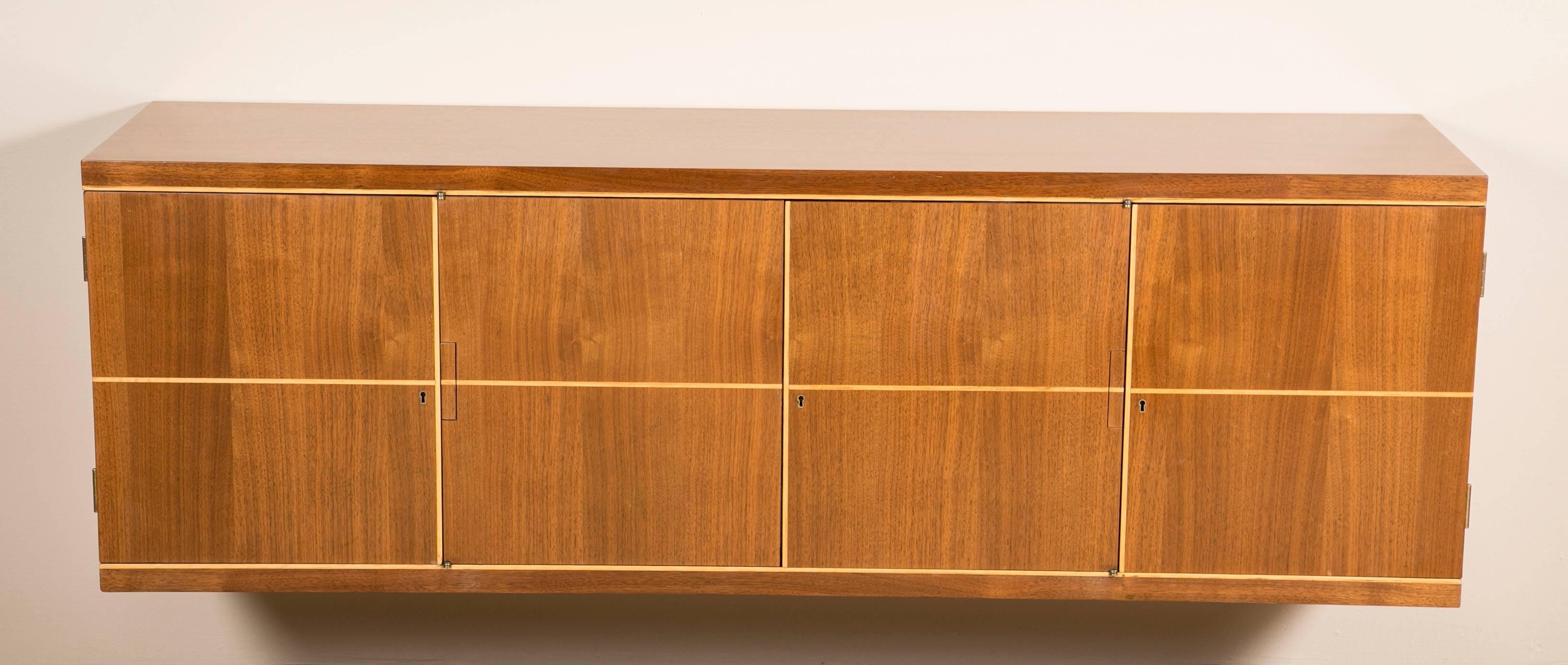 Tommi Parzinger design four-section walnut wall mounted credenza.