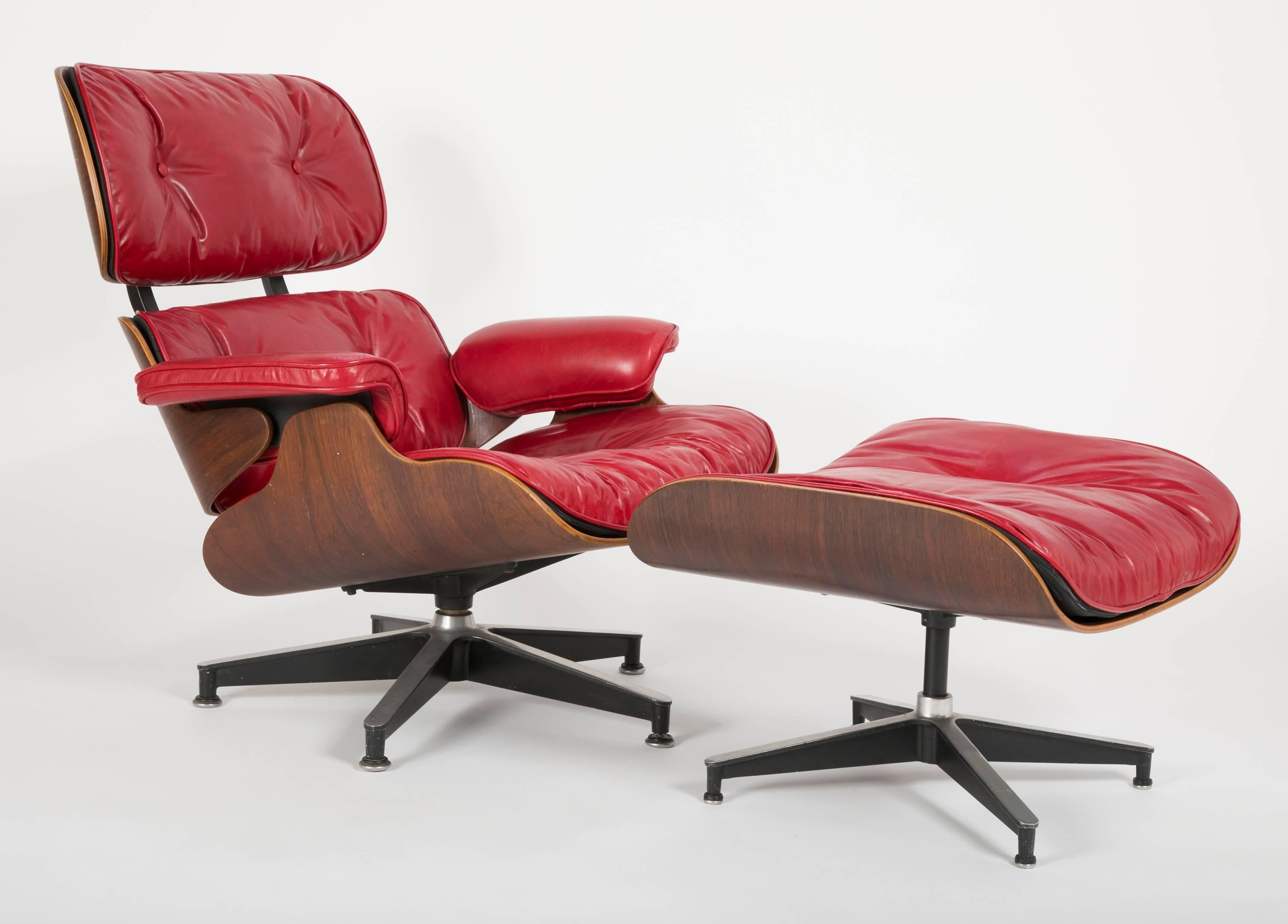 Eames Lounge 670 and Ottoman 671 in rosewood with red leather upholstery.