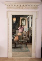 Pair of Door Surrounds and Pediments Framing Large Mirrors