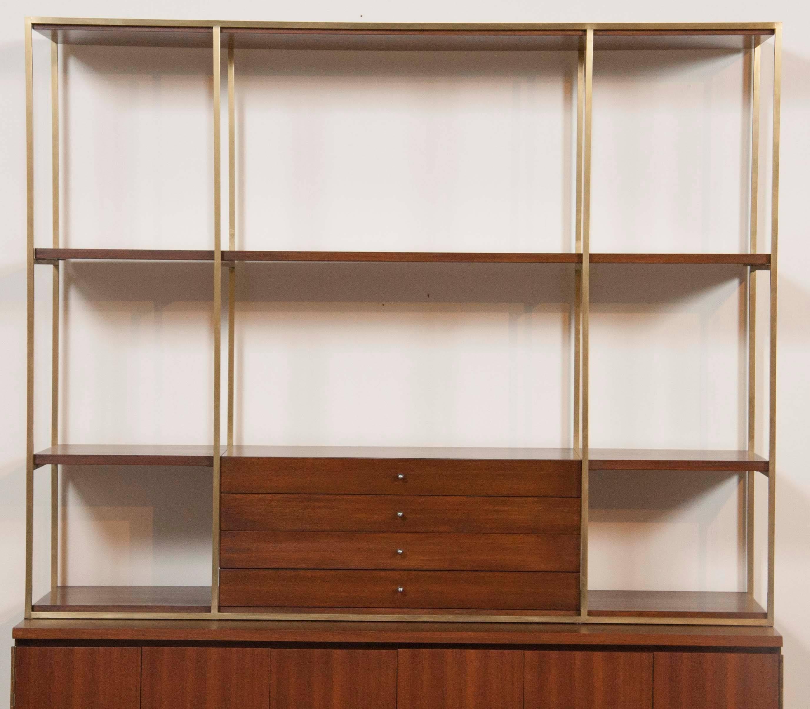 A Walnut and brass credenza with bookcase by Paul McCobb for Calvin, in excellent condition.