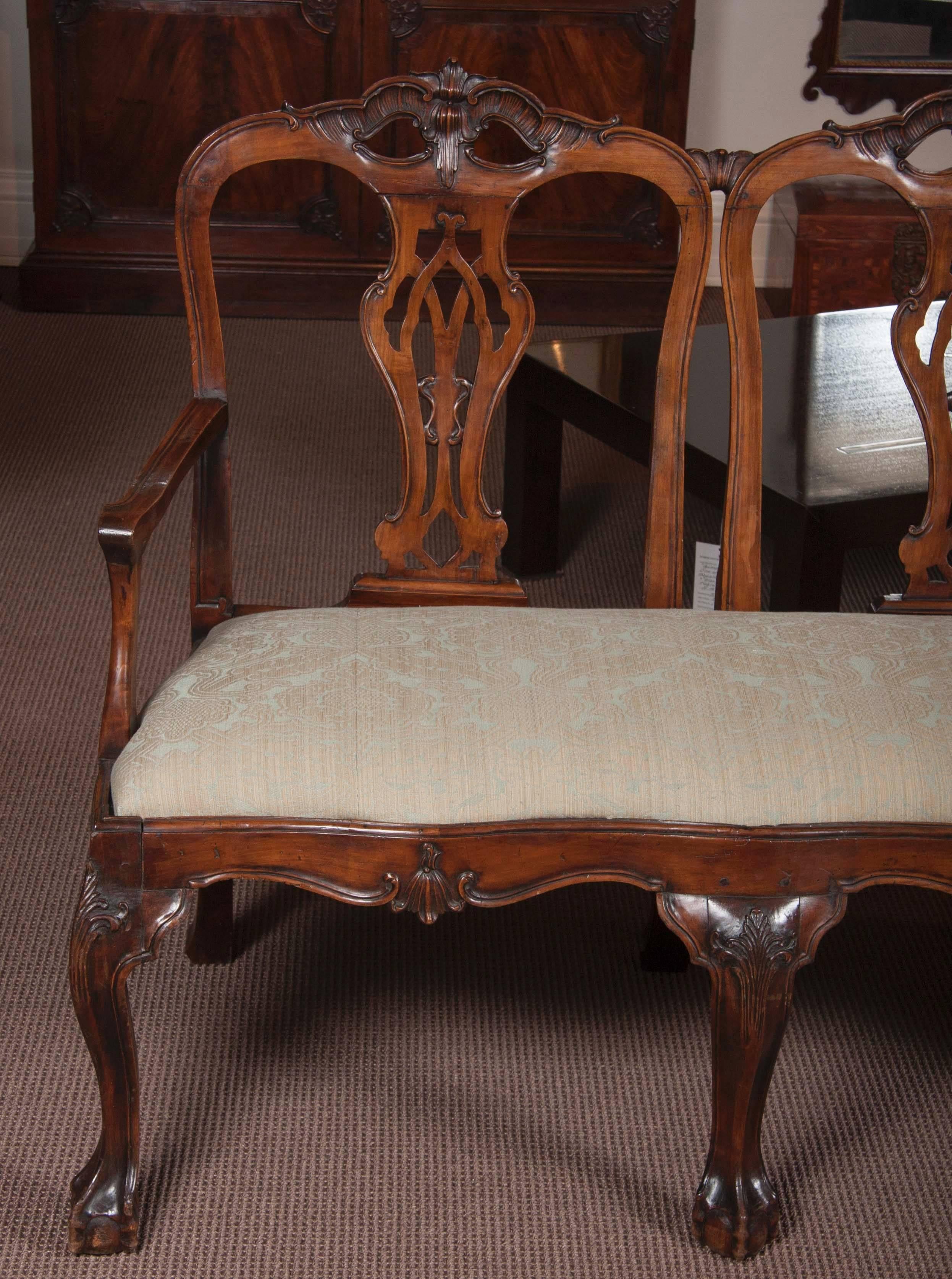 A Portuguese Rococo mahogany carved three-chair-back settee.