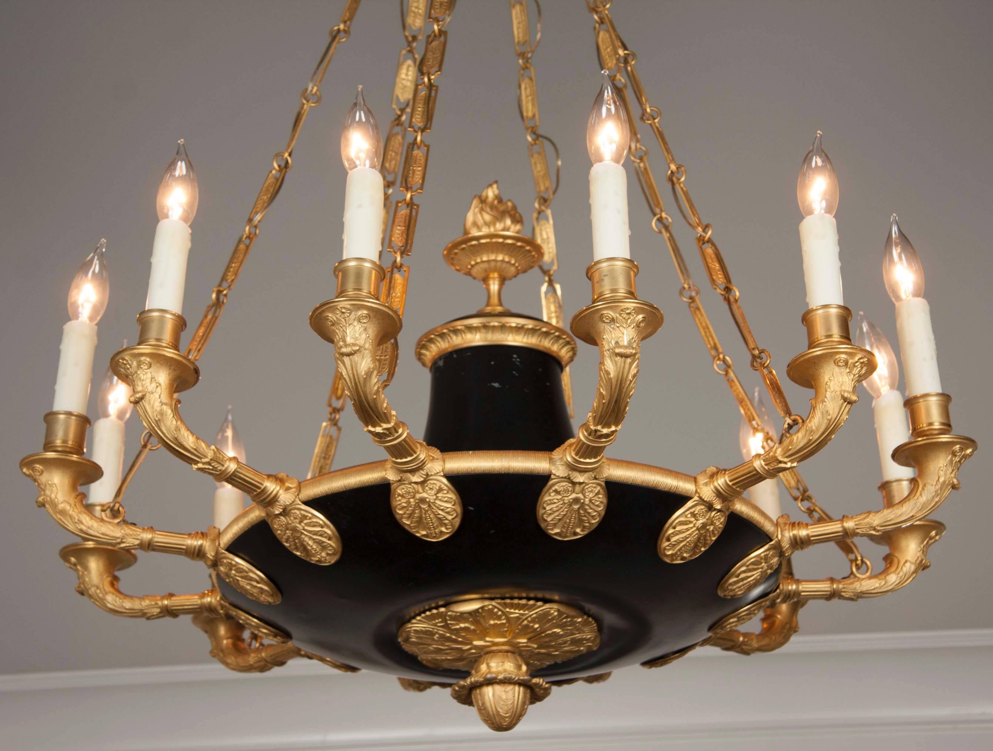 A French Empire bronze and ormolu, twelve-light chandelier.