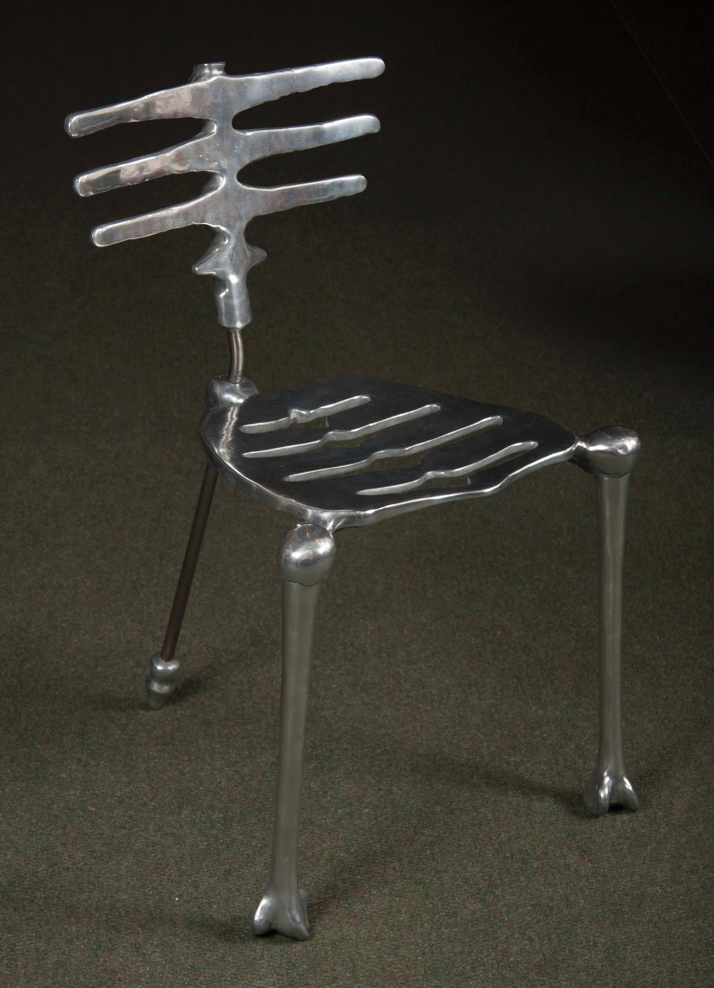 A polished aluminum skeleton form side chair by Michael Aram.