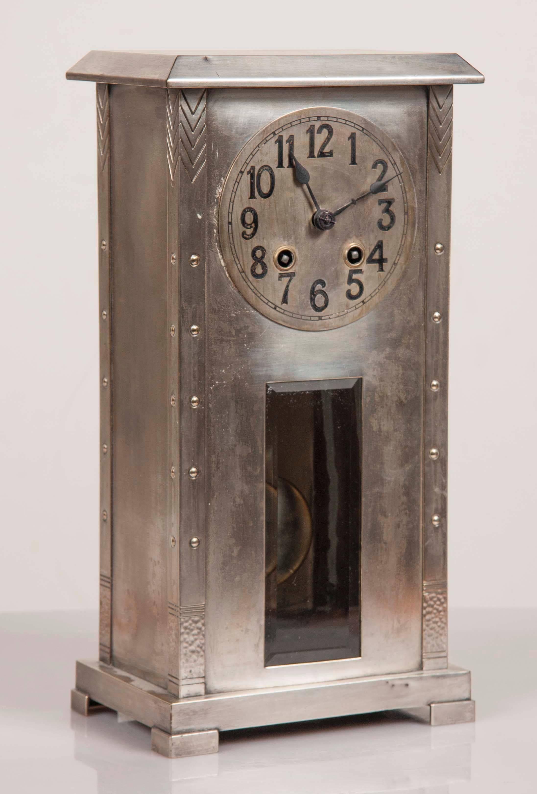 A WMF case clock with pendulum circa 1910.  The clock has hallmarks indicating that it is silver plate over Britannia metal with an oxidized finish.  