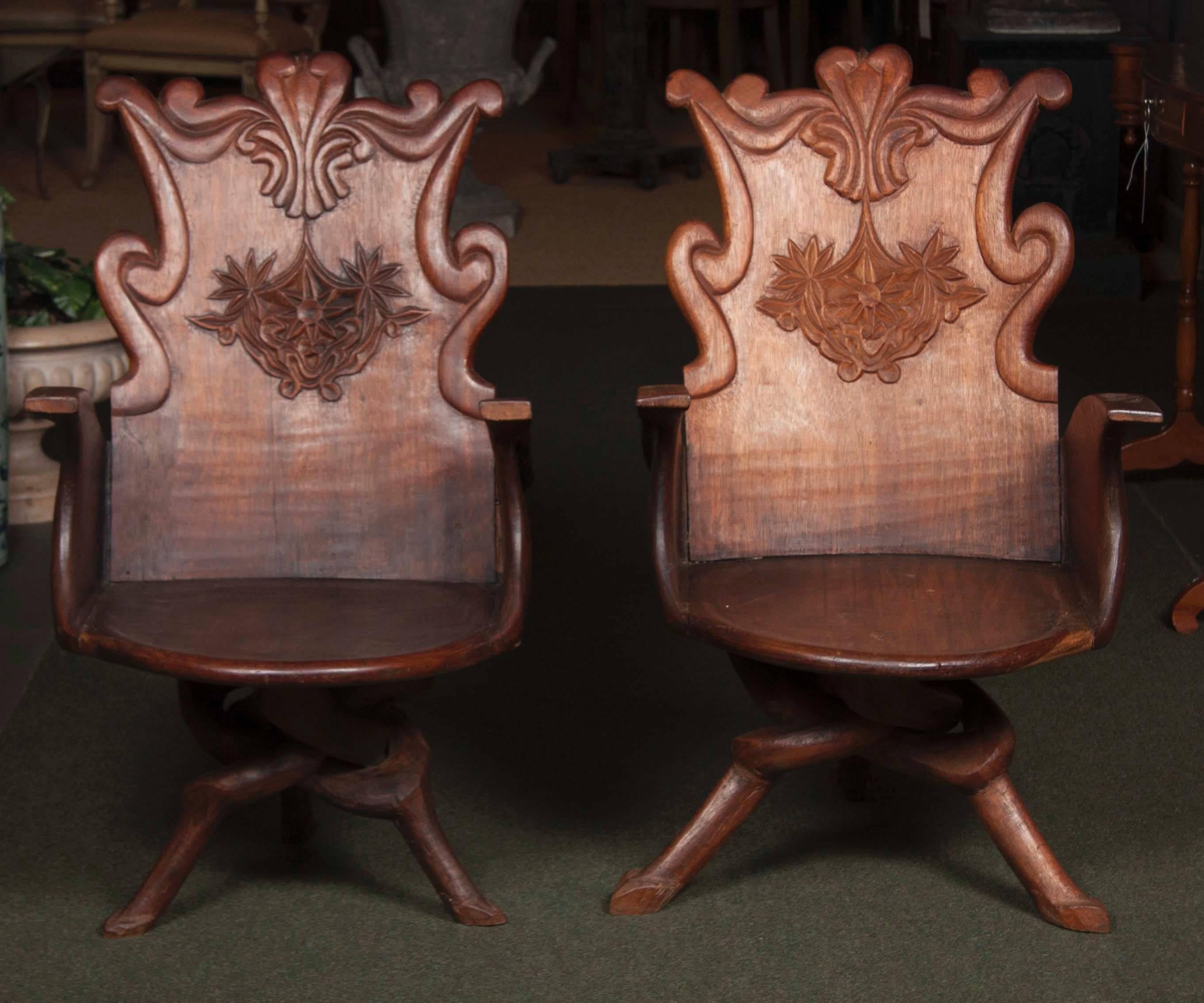 Pair of 19th century Art Nouveau Gaudi style Spanish arm chairs with scroll arms with scroll back all on three intertwined hoof footed legs.