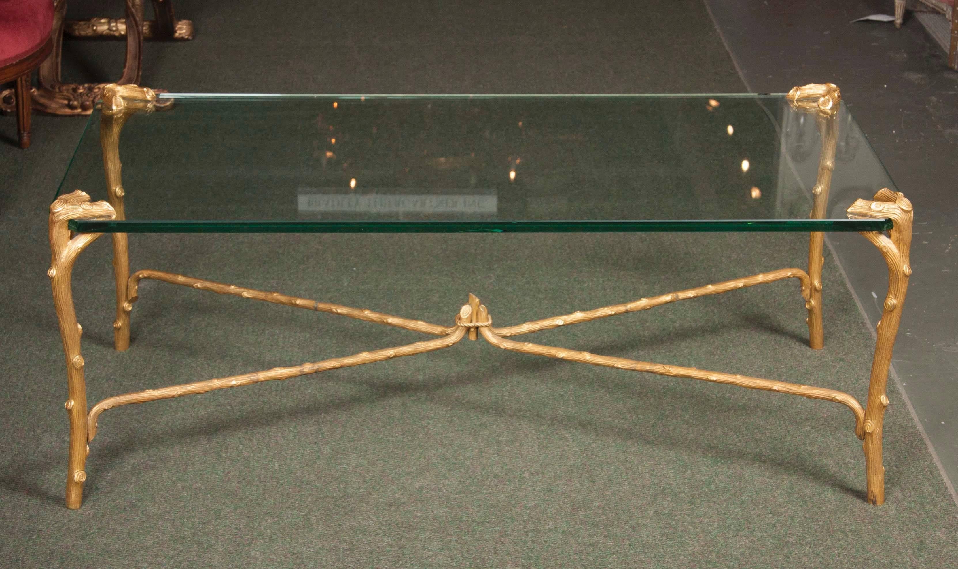 A mid-20th century faux-bois, 24-karat gold-plated brass coffee table by  P. E. Guerin,  with glass top.
Popularized by Melanie Kahane in the 1960s.